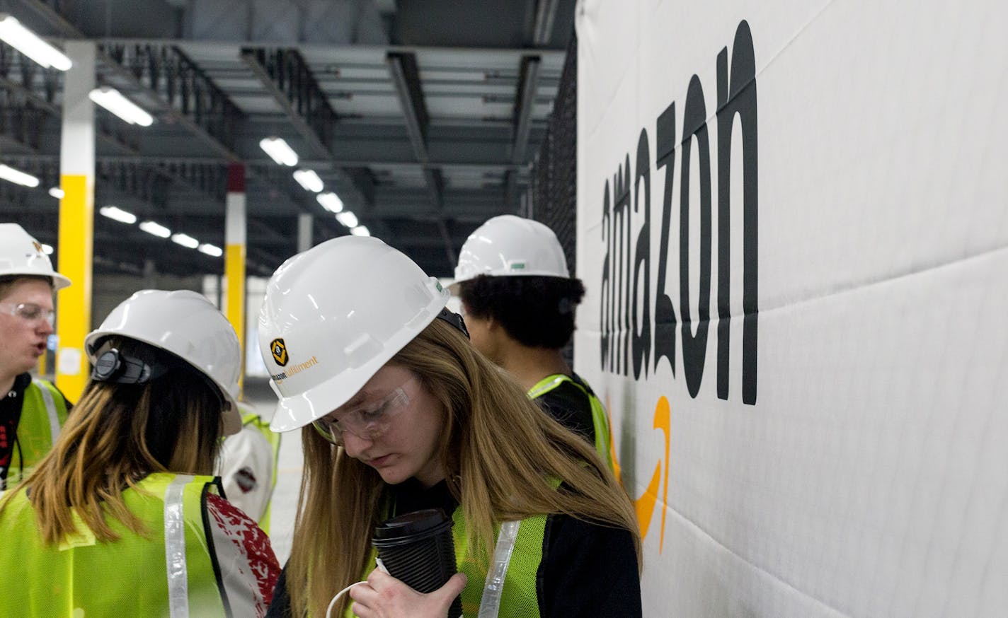 School students with a robotics team visited the Amazon Shakopee fulfillment center before it opened. The facility is now headed toward 2,500 employees.