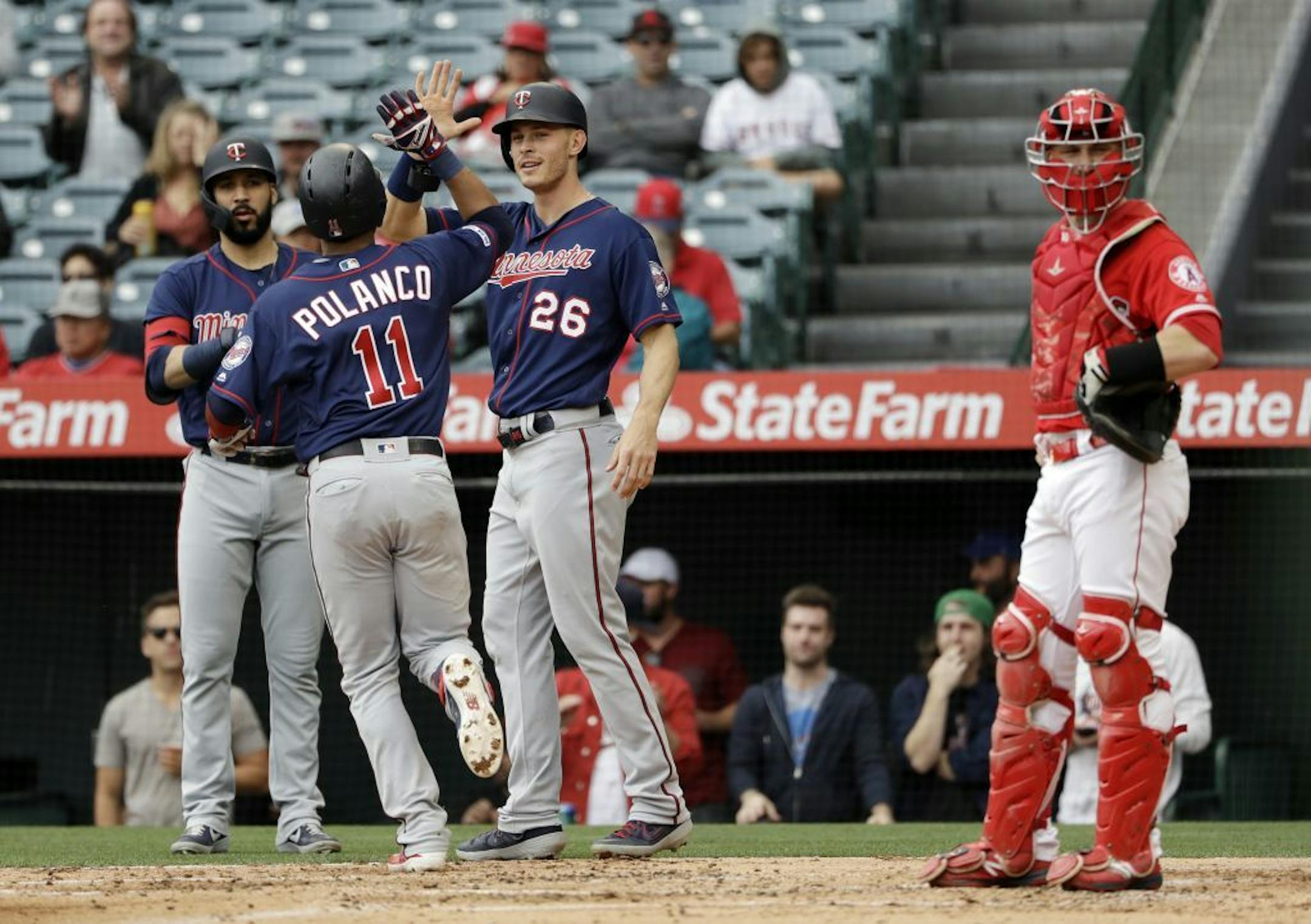 Minnesota Twins' Jorge Polanco (11) celebrates his two-run home run with teammate Max Kepler (26) during the second inning of a baseball game against the Los Angeles Angels Thursday, May 23, 2019, in Anaheim, Calif.