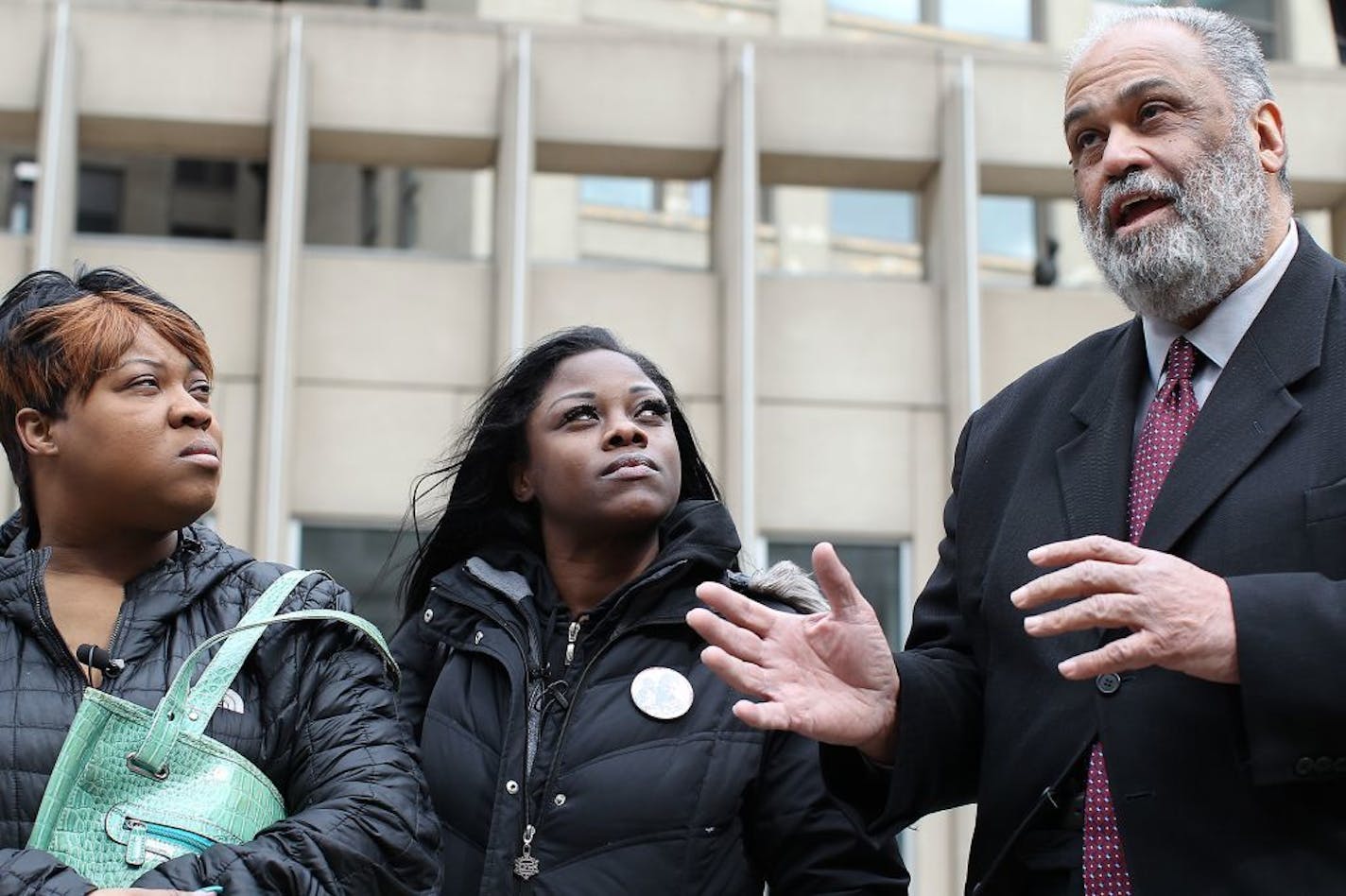 Jamar Clark's siblings Sharice Burns, left, and Tiffany Roberson, listened to attorney Albert Goins after the decision not to use a grand jury was announced Wednesday.