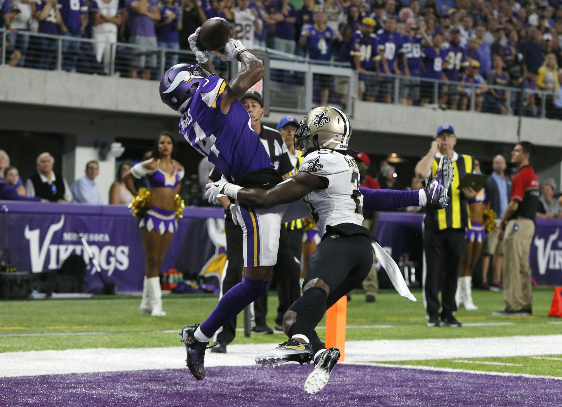 FILE - In this Sept. 11, 2017, file photo, Minnesota Vikings wide receiver Stefon Diggs, left, catches a 2-yard touchdown pass over New Orleans Saints cornerback De'Vante Harris during the first half of an NFL football game in Minneapolis. The Vikings finally have their first postseason opponent set with the Saints, a team they beat handily in the opener when both teams looked a lot different than they do now. (AP Photo/Bruce Kluckhohn, File)