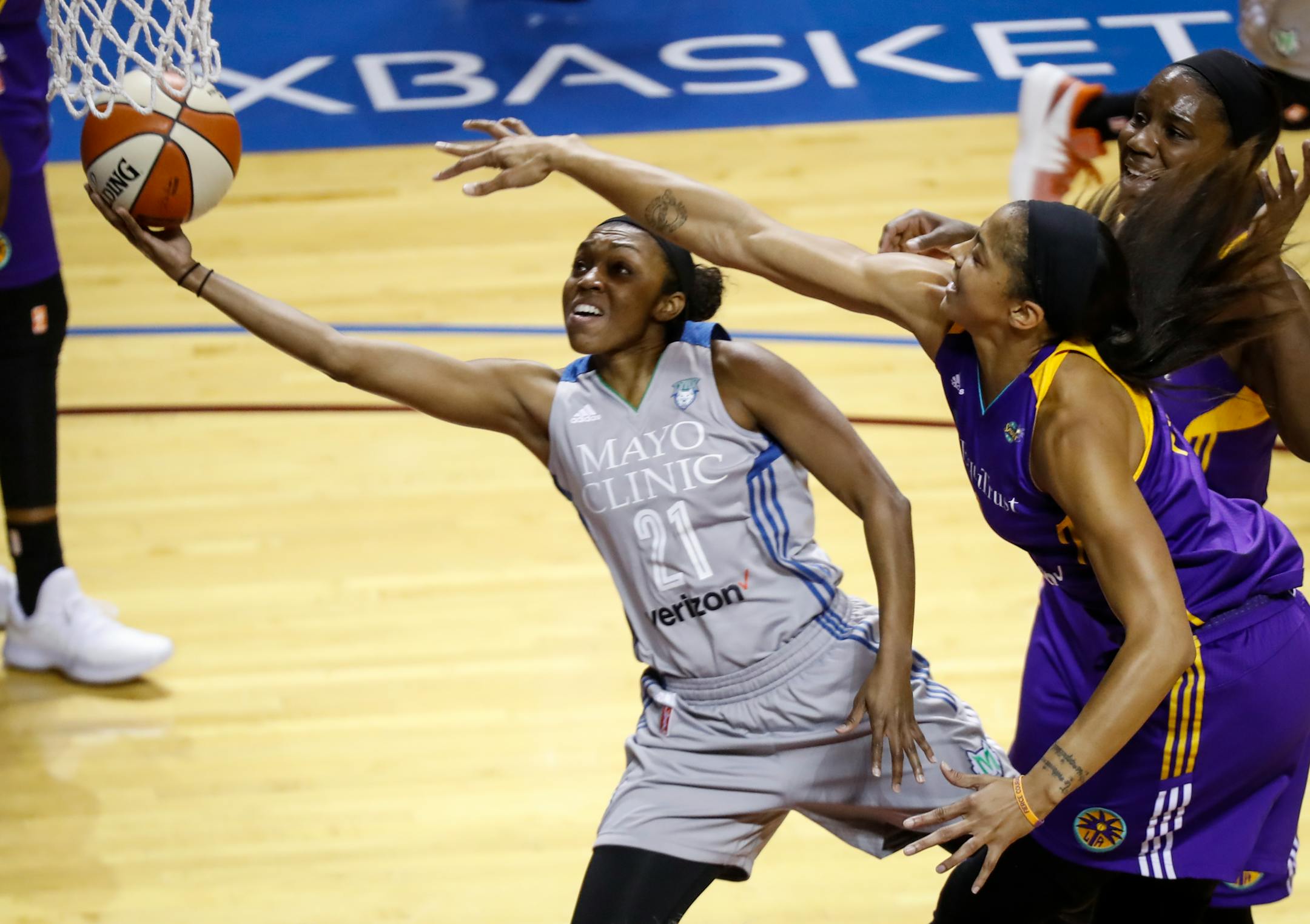 Lynx guard Renee Montgomery (21) shoots as Los Angeles Sparks forward Candace Parker (3), right front, defends during Game 2.