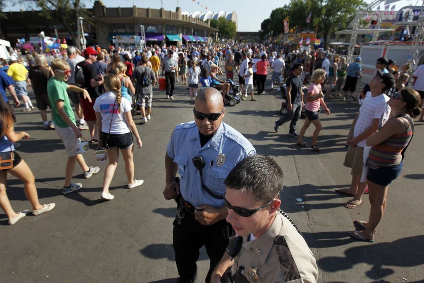 Timbutu Wilkerson of the Minnesota State Fair Police and Nathan Timm, a Goodhue County Sheriff deputy walked the fair grounds on Monday.