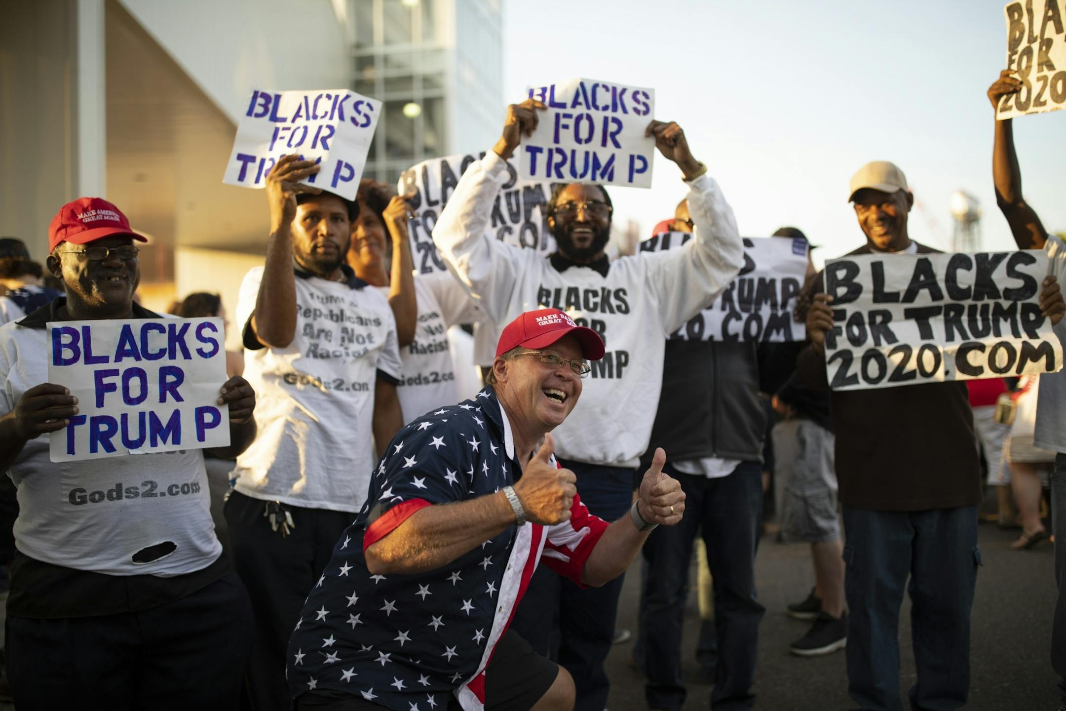 A Trump supporter posed for a keepsake photo with a group of men holding signs supporting the President.
