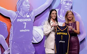 Iowa's Caitlin Clark, left, poses for a photo with WNBA commissioner Cathy Engelbert after being selected first overall by the Indiana Fever.