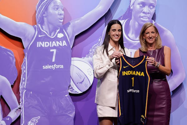 Iowa's Caitlin Clark, left, poses for a photo with WNBA commissioner Cathy Engelbert after being selected first overall by the Indiana Fever.