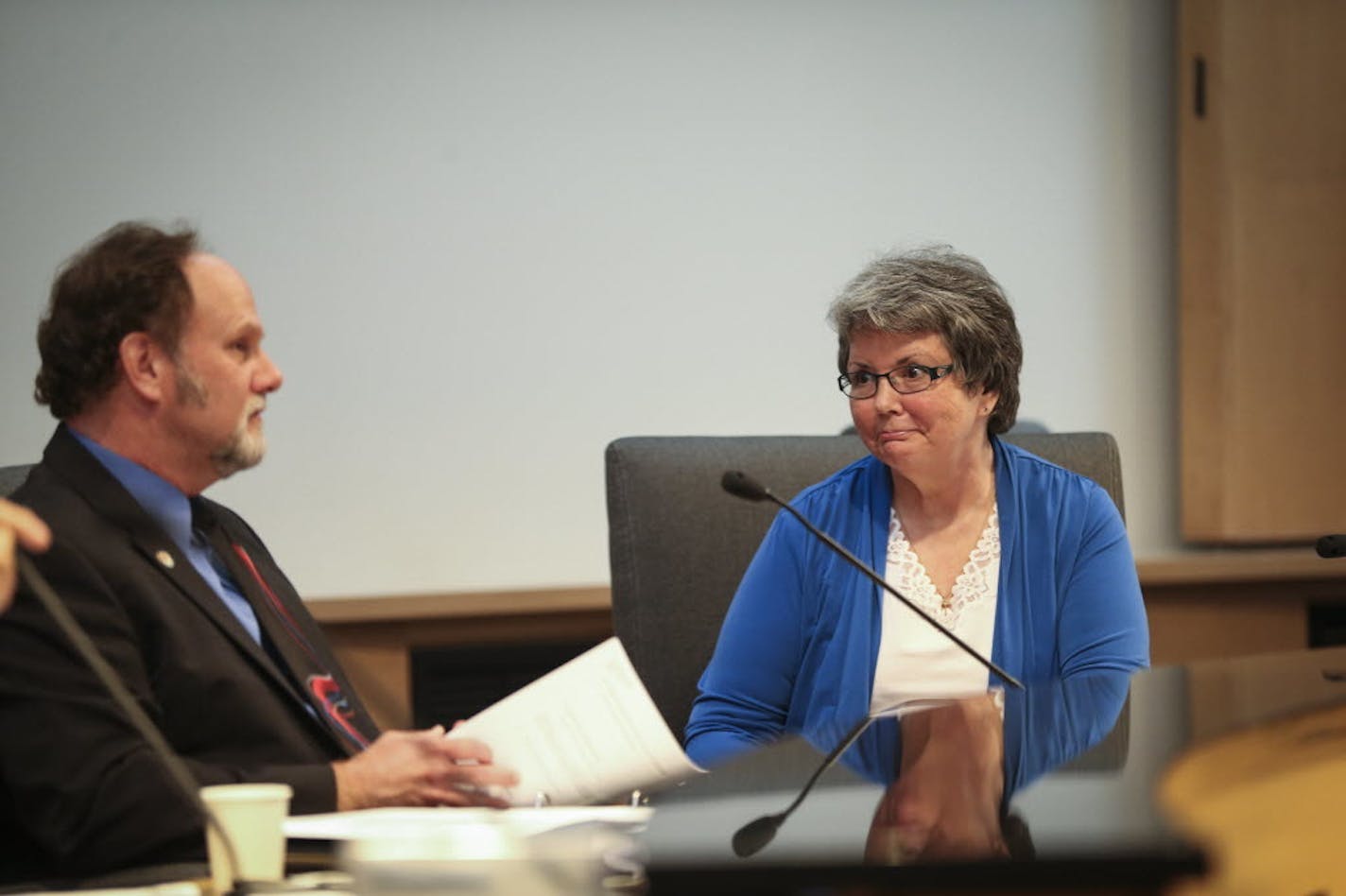 Council Member LeAnn Sargent chatted with fellow council members before a City Council meeting on Monday, August 4, 2014, in Maple Grove.