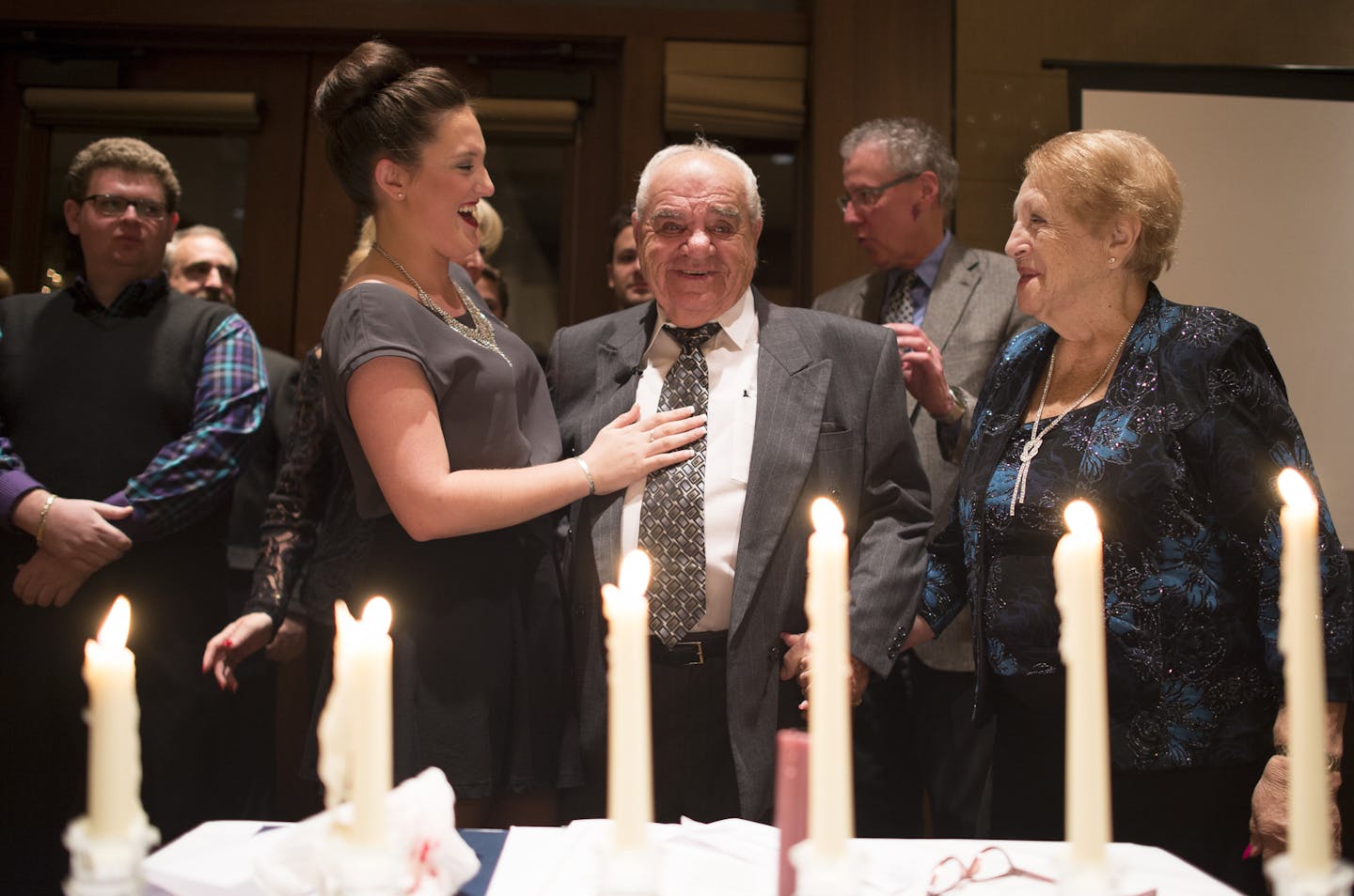 Sydney Mandel, left of center, shares a moment with her grandfather, Mark Mandel, during a ceremony memorializing the six million Jews who were killed in the Holocaust as well as celebrating the lives of the Mandelbaum family's survivors. ] (Aaron Lavinsky | StarTribune) Seventy years ago, five survivors of Polish concentration camps for Jews were freed. The siblings eventually moved to Minnesota, and three of them are still here and alive today. Last weekend, their families -- now 133 descendan