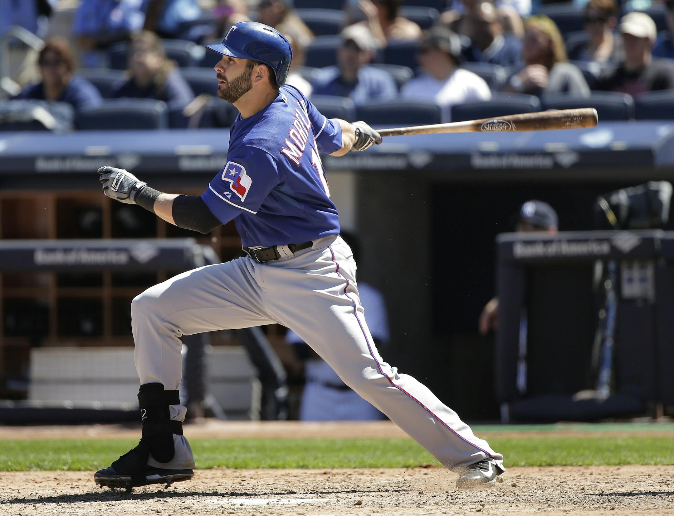 Texas Rangers first baseman Mitch Moreland (18) follows through on a hit against the New York Yankees during the eighth inning of a baseball game, Saturday, May 23, 2015, in New York. (AP Photo/Julie Jacobson)