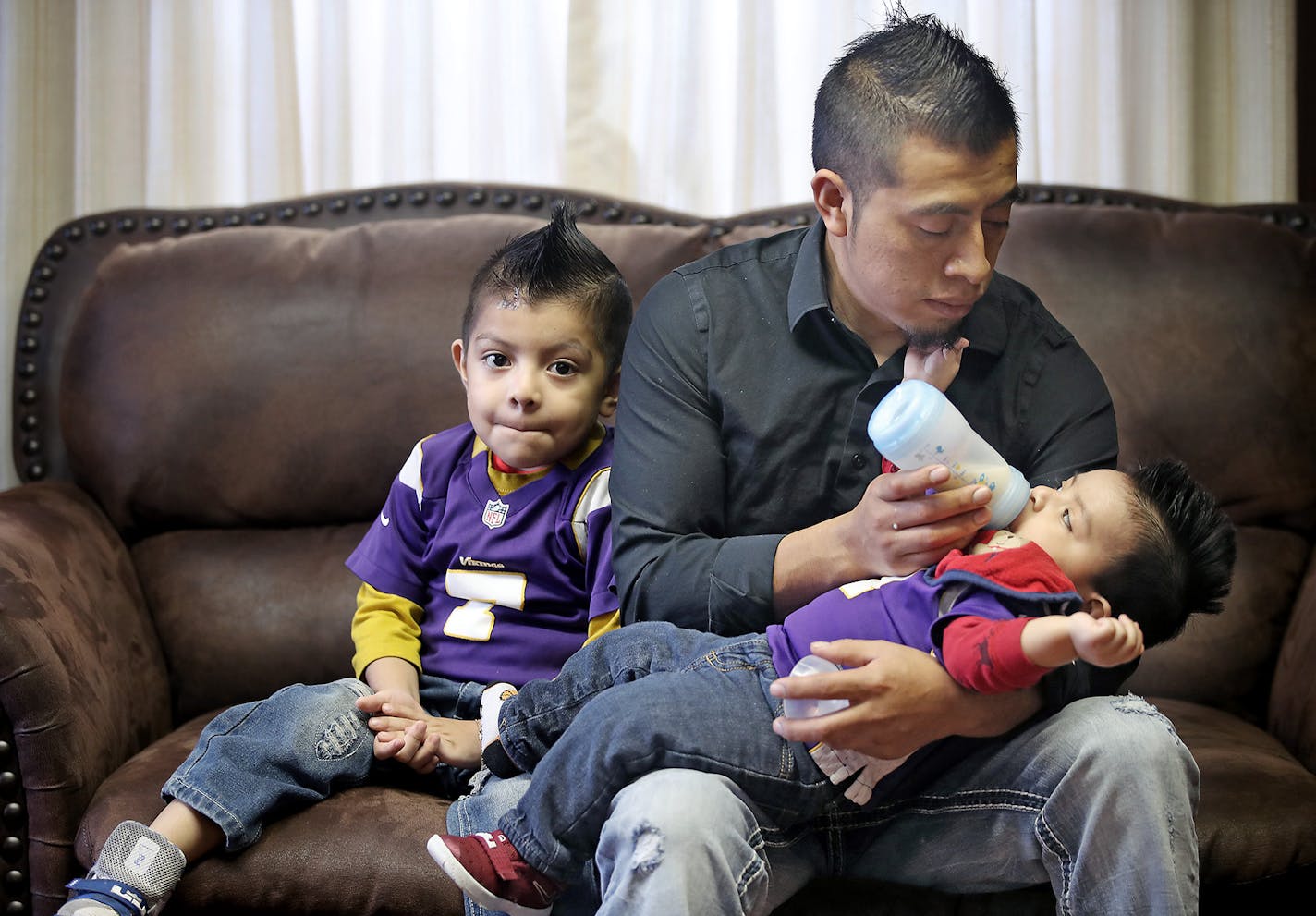 Eligio, a member at St. Mary's Catholic Church, took care of his two sons, born after he came to the U.S. looking for work. "We don't have to be afraid. The only thing we are doing is working hard."