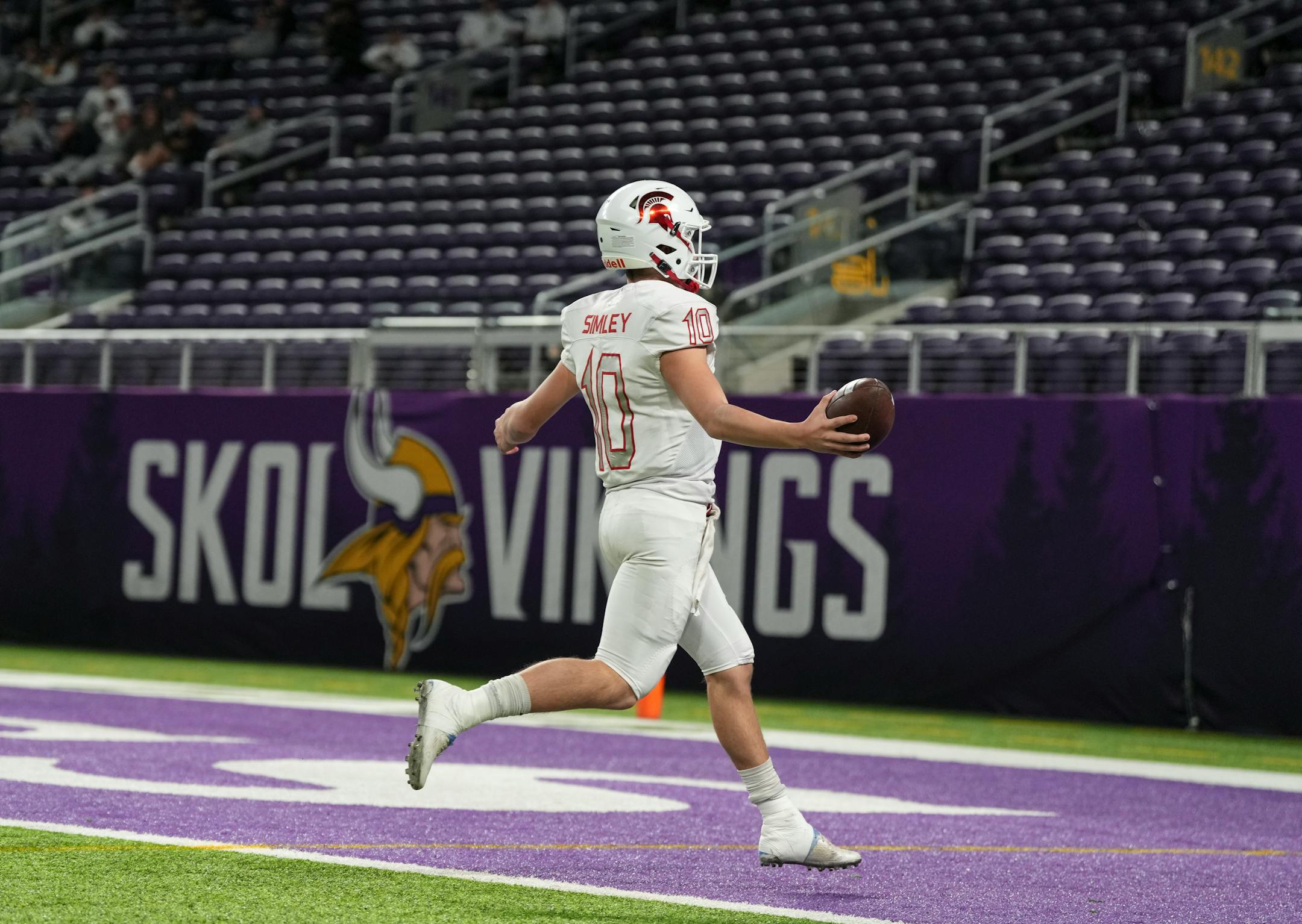 Simley Spartans quarterback Caden Renslow (10) scores a touchdown during the first half.