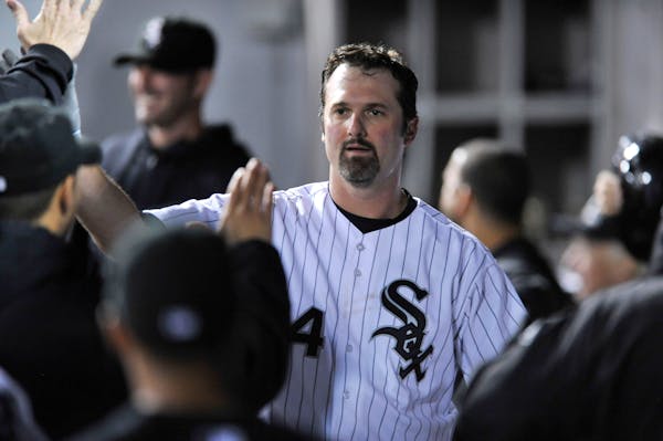 The White Sox's Paul Konerko celebrated with teammates in the dugout after scoring on a Gordon Beckham single during the first inning of a 12-1 victor