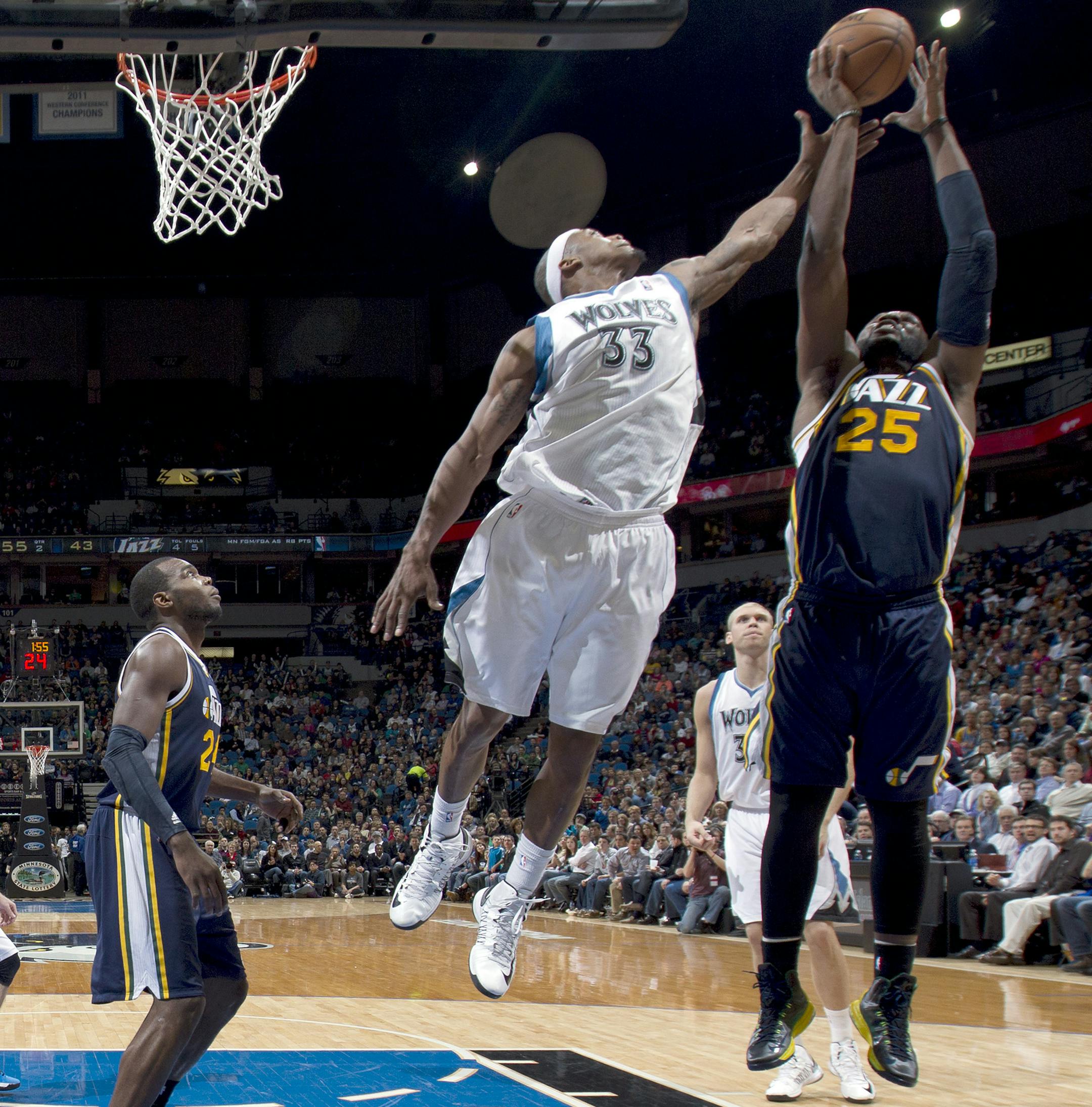Dante Cunningham (33) and Al Jefferson (25) fought for a rebound in the second quarter. Utah beat Minnesota by a final score of 96-80. ] CARLOS GONZALEZ cgonzalez@startribune.com April 15, 2013, Minneapolis, Minn., Target Center, NBA, Minnesota Timberwolves vs. Utah Jazz