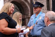 Officer Jacob Spies was joined by wife, Holly, and 12-year-old daughter Olivia at the award ceremony outside Minneapolis City Hall on Thursday, Aug. 2