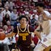 Gophers guard Mike Mitchell Jr. (2) makes a pass against Indiana center Kel'el Ware on Jan. 12 in Bloomington, Ind.