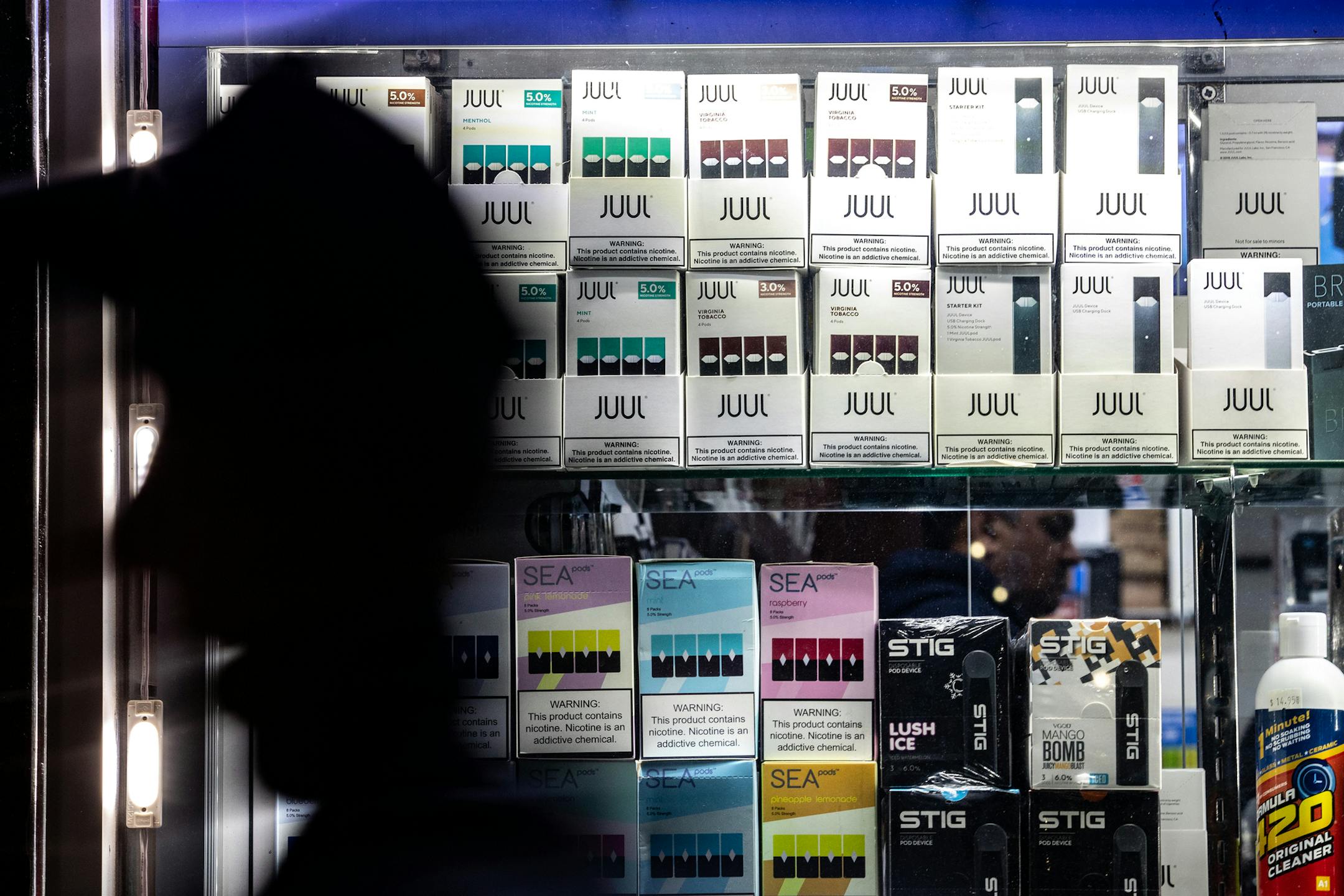 FILE -- Juul products and some competitors at a smoke shop in Manhattan, Nov. 10, 2019. Juul Labs says its focus was always adult smokers, but targeting young nonsmokers was also part of the plan, according to interviews with former executives, employees and investors, along with reviews of legal filings and social media archives. (Jeenah Moon/The New York Times)
