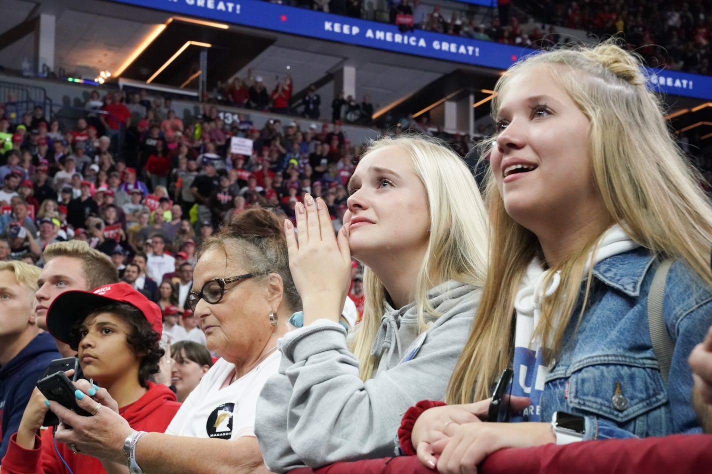 With tears running down their cheeks Brooklyn Hanneman, left, of Lino Lakes and Katie Bohn from Centerville watched President Trump. President Donald Trump greeted cheering crowds at the Target Center in Minneapolis, Minnesota.