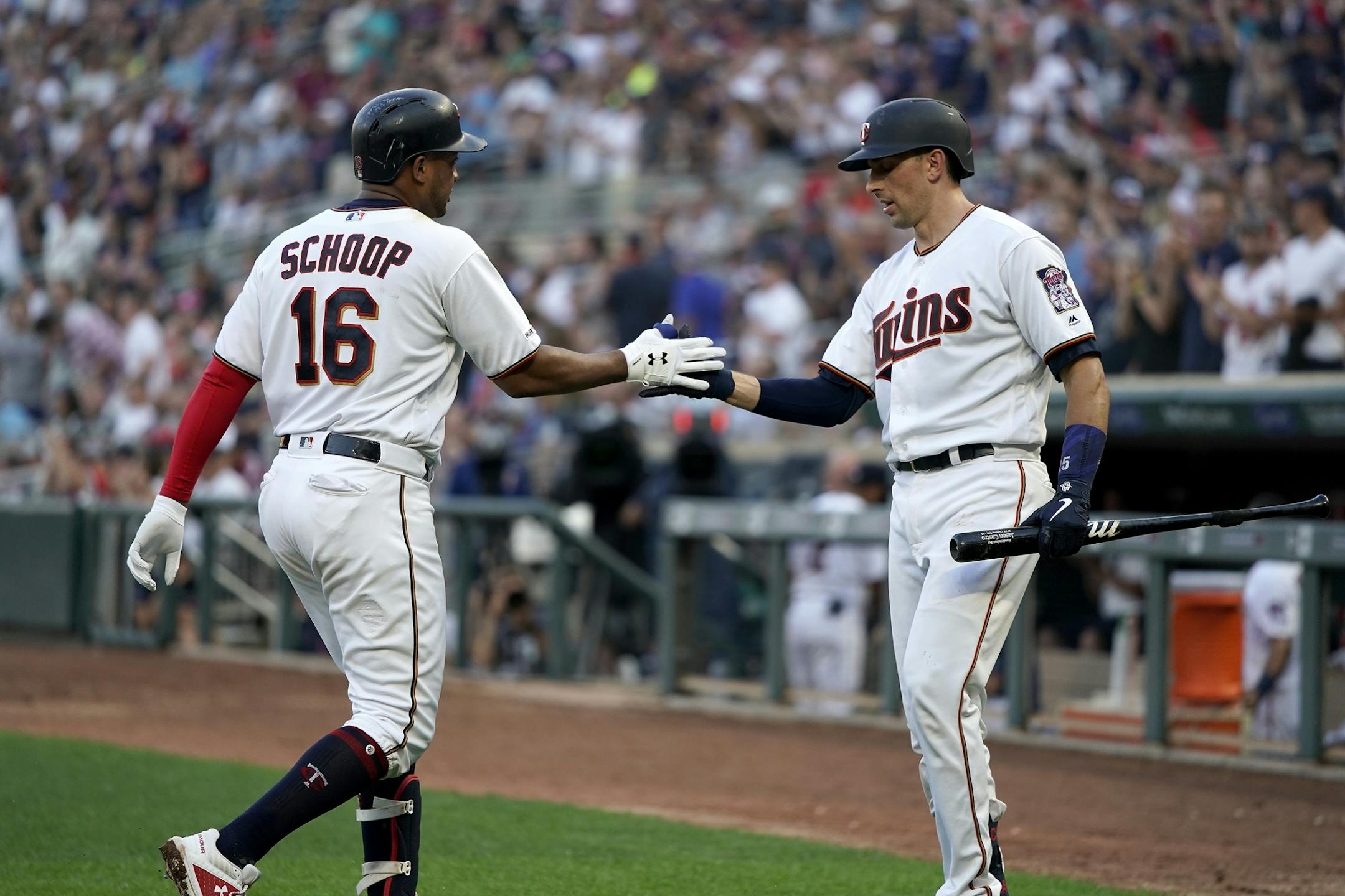 Minnesota Twins second baseman Jonathan Schoop (16) celebrates his home run with Minnesota Twins catcher Jason Castro (15) during the third inning.