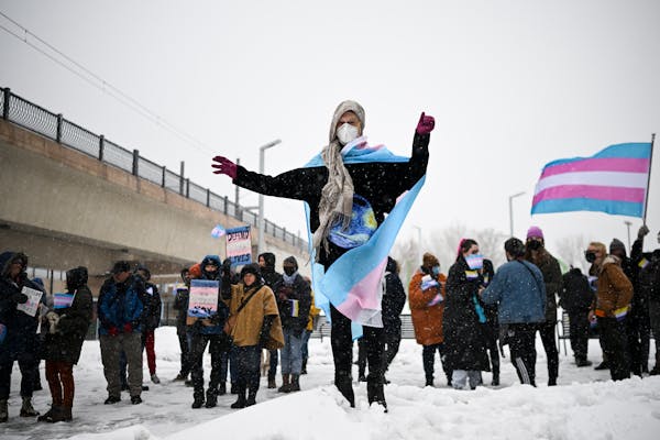 Ellie Cawhorn, of Minneapolis, dances atop a snow pile Thursday, March 9, 2023 at the Lake Street/Midtown Transit Station in Minneapolis, Minn.. "I'm 