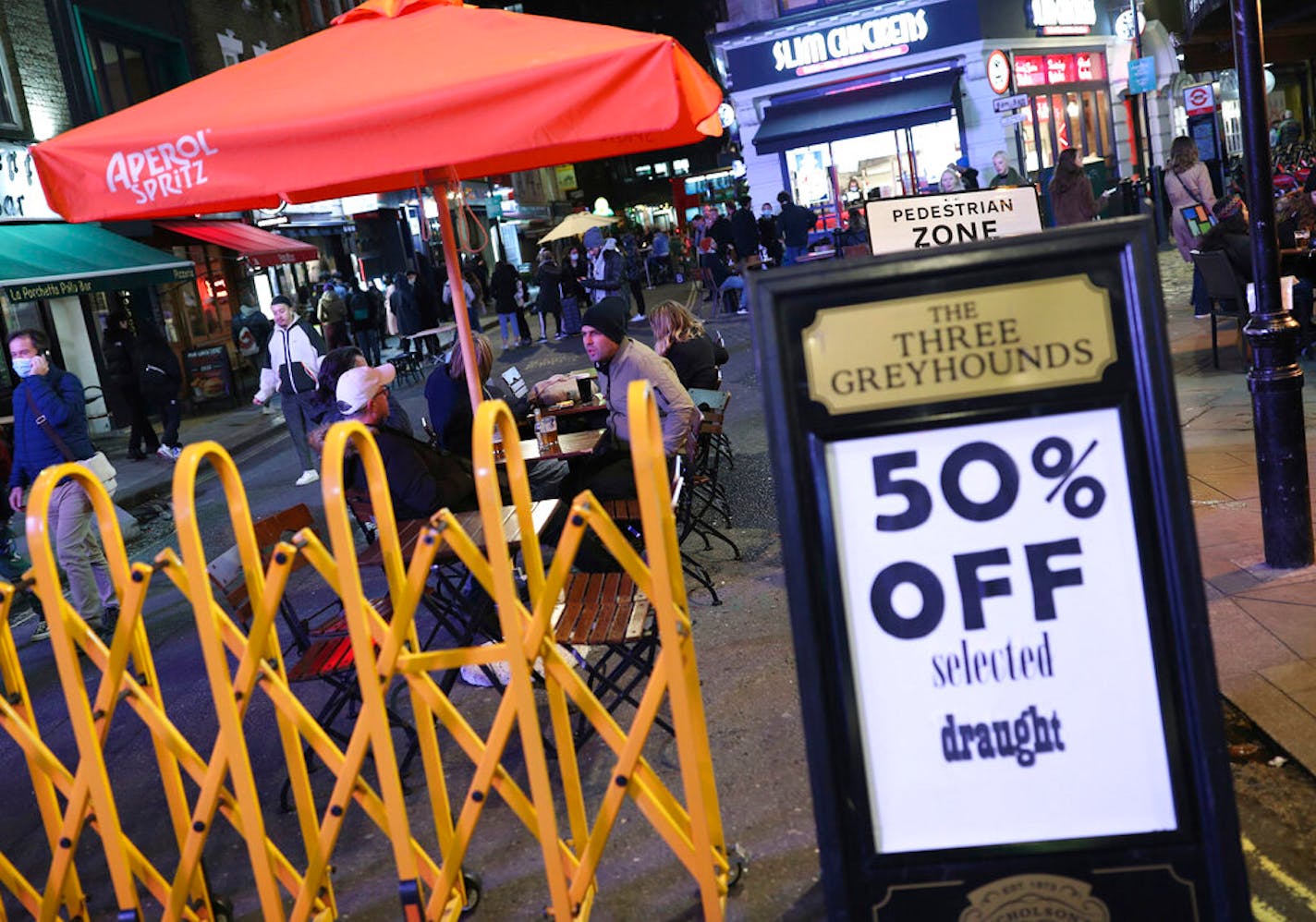 A pub offers 50 percent off some alcoholic beers, for drinkers in the Soho area of central London, Tuesday Nov. 3, 2020, ahead of a new national lockdown for England from Thursday.