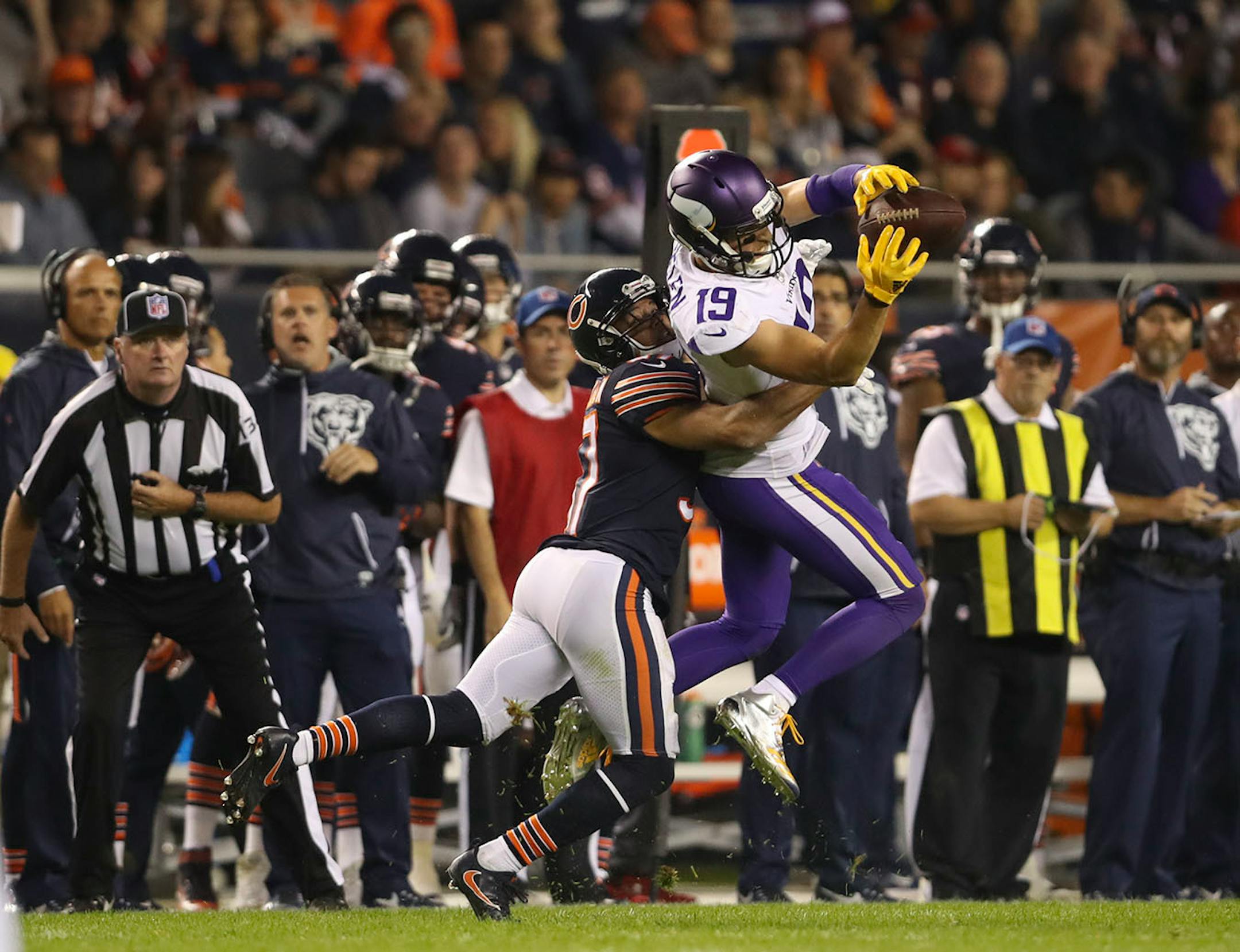 Minnesota Vikings wide receiver Adam Thielen (19) caught an 11 yard pass while covered by Chicago Bears outside linebacker Leonard Floyd (94) on a third quarter scoring drive.