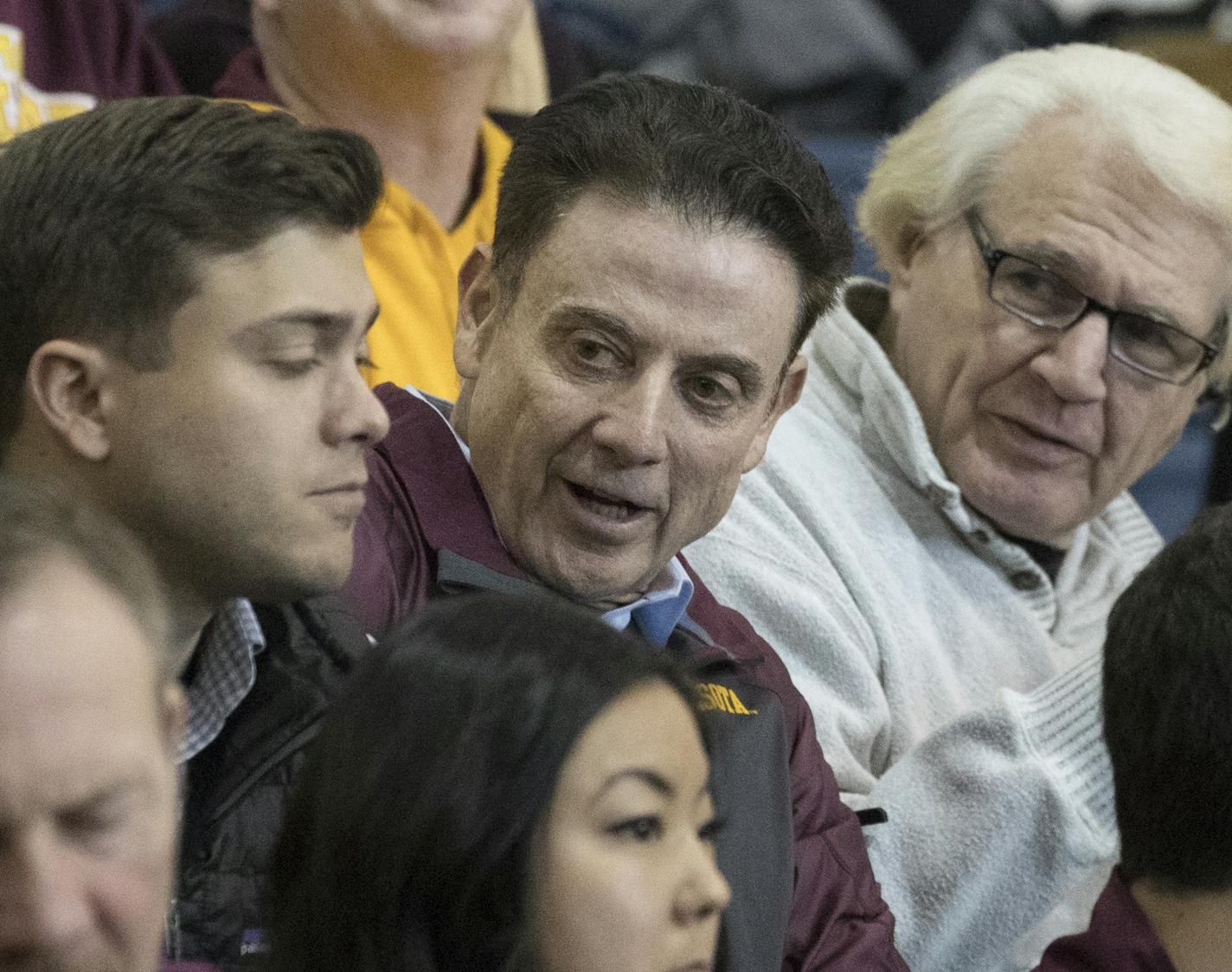 Former Louisville head coach Rick Pitino, third from left, is seen in the stands during the first half of an NCAA college basketball game between Minnesota and UMass, Friday, Nov. 24, 2017, in New York. Minnesota won 69-51. (AP Photo/Mary Altaffer)