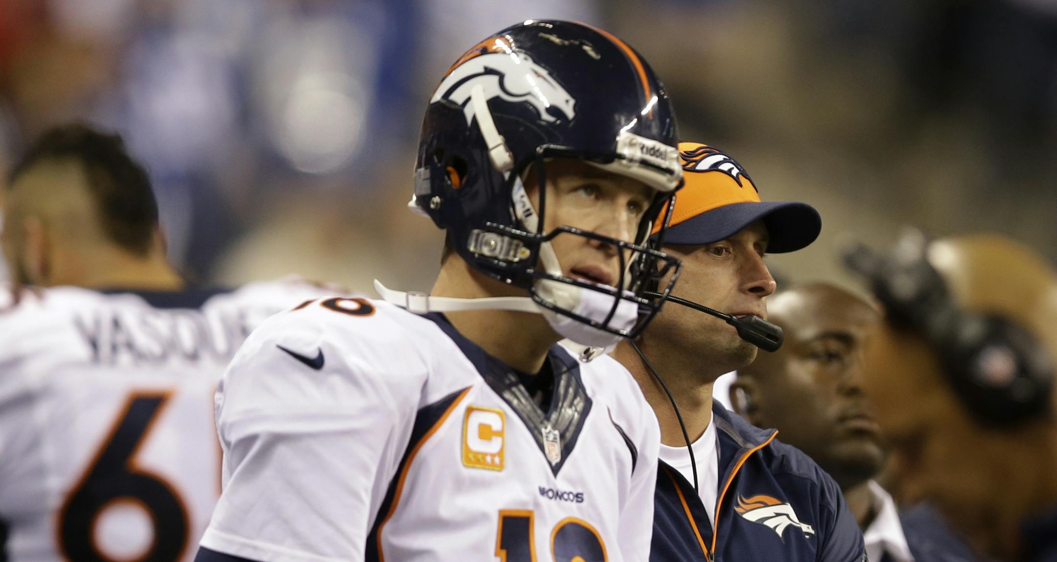 Denver Broncos quarterback Peyton Manning (18) watches from the sideline during the second half of an NFL football game against the Indianapolis Colts, Sunday, Oct. 20, 2013, in Indianapolis. (AP Photo/Michael Conroy)