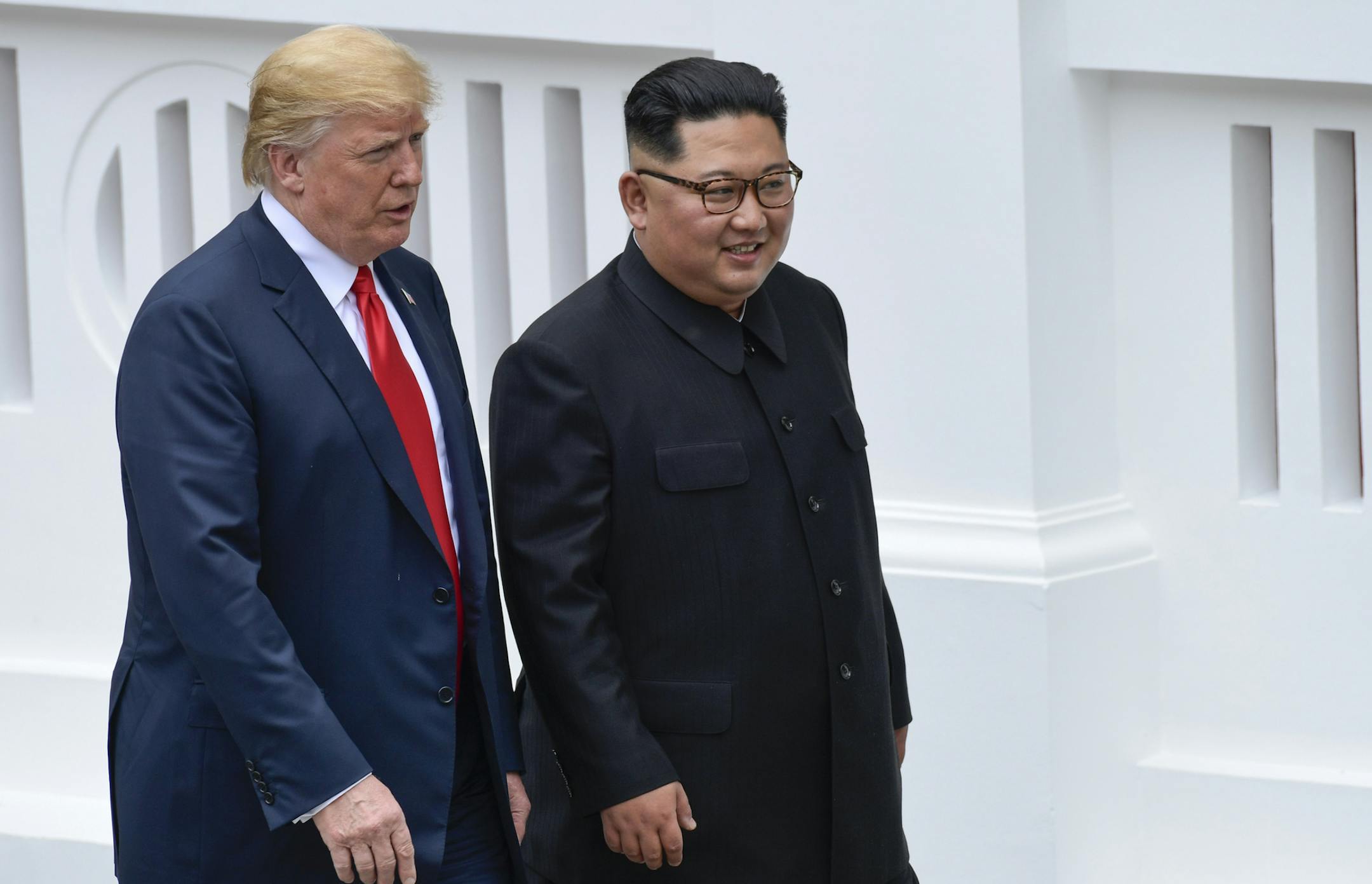 U.S. President Donald Trump and North Korea leader Kim Jong Un walk from lunch at the Capella resort on Sentosa Island Tuesday, June 12, 2018 in Singapore. (AP Photo/Susan Walsh, Pool)