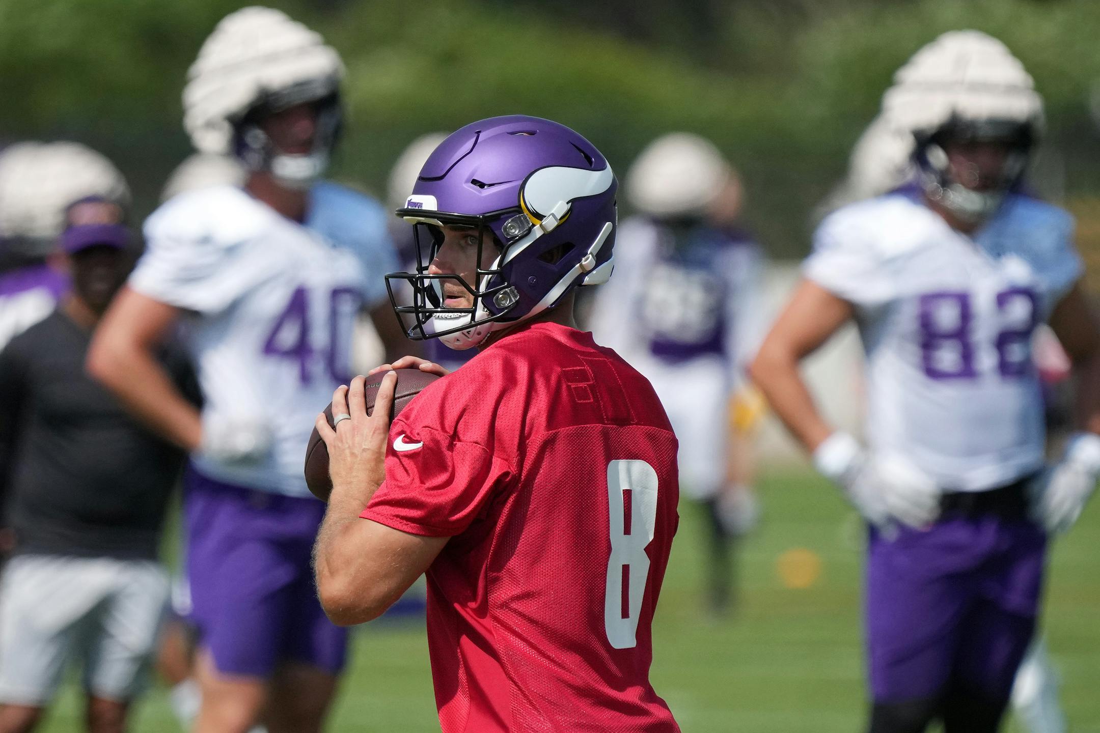 Minnesota Vikings quarterback Kirk Cousins (8) searches for an open receiver during training camp.