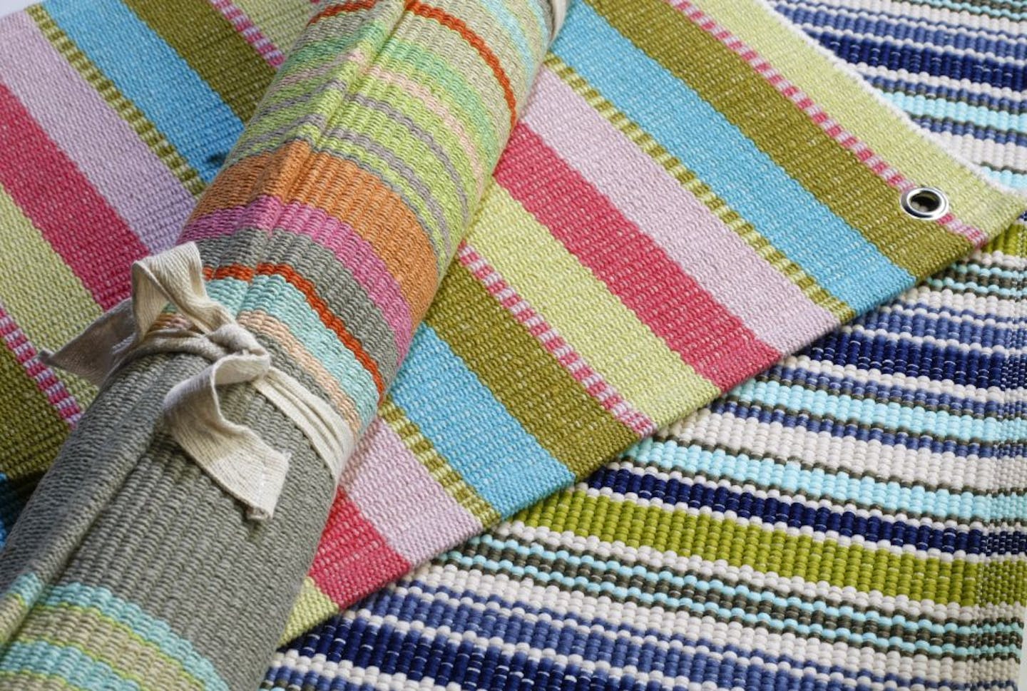 Area rugs are easy ways to add warmth to a room, from a child's room to the laundry room. Dash and Albert hand-woven cotton rugs in Cabana and Stone Soup mix turquoise with pinks, corals, khakis and blues.