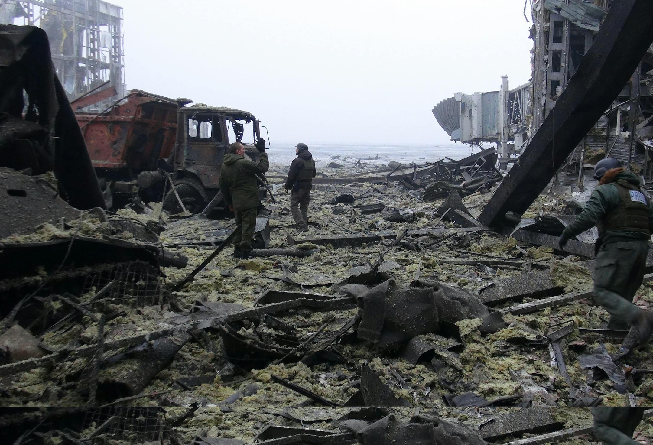 Donetsk People's Republic (DPR) soldiers of the "Sparta" squad clear debris in the destroyed Donetsk Airport on Wednesday, Jan. 21, 2015. The airport fell to the pro-Russia separatists after weeks of fighting between DPR soldiers and the Ukrainian government's troops. (Nikolai Muravyev/TASS/Zuma Press/TNS)