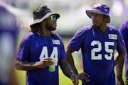 Safetys Josh Metellus (44) and Theo Jackson (25) chat as they walk off the field following walk-throughs at Minnesota Vikings practice at TCO Performa