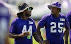 Safetys Josh Metellus (44) and Theo Jackson (25) chat as they walk off the field following walk-throughs at Minnesota Vikings practice at TCO Performa