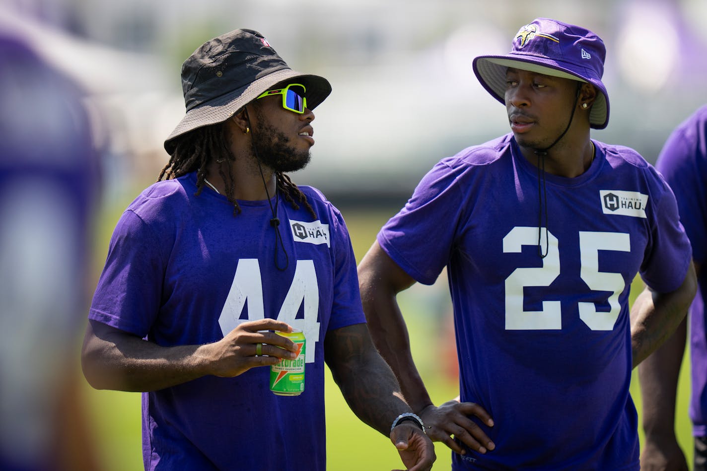 Safetys Josh Metellus (44) and Theo Jackson (25) chat as they walk off the field following walk-throughs at Minnesota Vikings practice at TCO Performance Center.