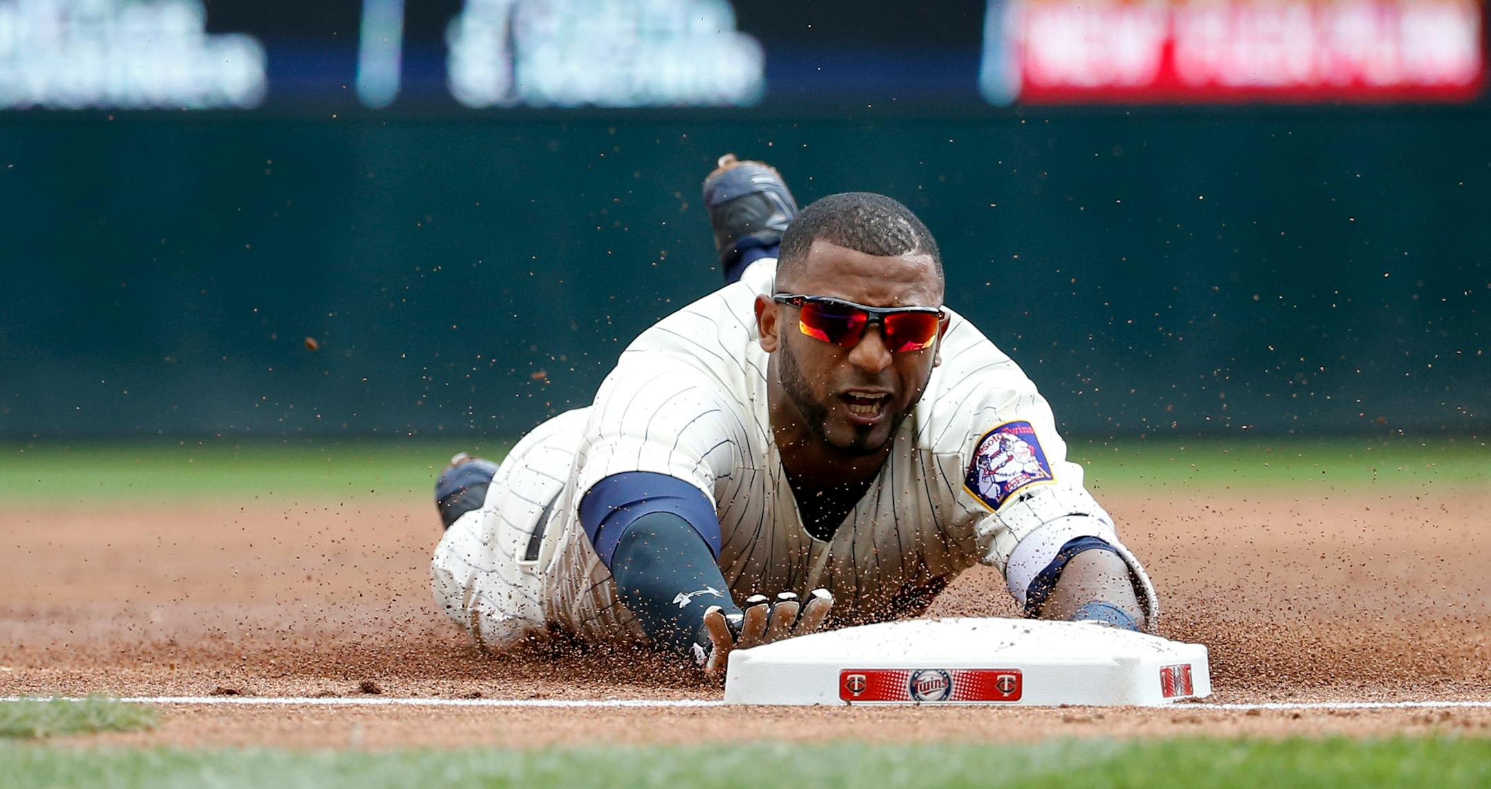 Minnesota Twins' Eduardo Nunez dives safely into third base with a triple off Los Angeles Angels starting pitcher Jered Weaver during the first inning of a baseball game in Minneapolis, Saturday, April 16, 2016. (AP Photo/Ann Heisenfelt)