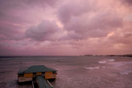Day breaks over a pier as Hurricane Beryl passes through Bridgetown, Barbados, Monday, July 1, 2024. (AP Photo/Ricardo Mazalan)