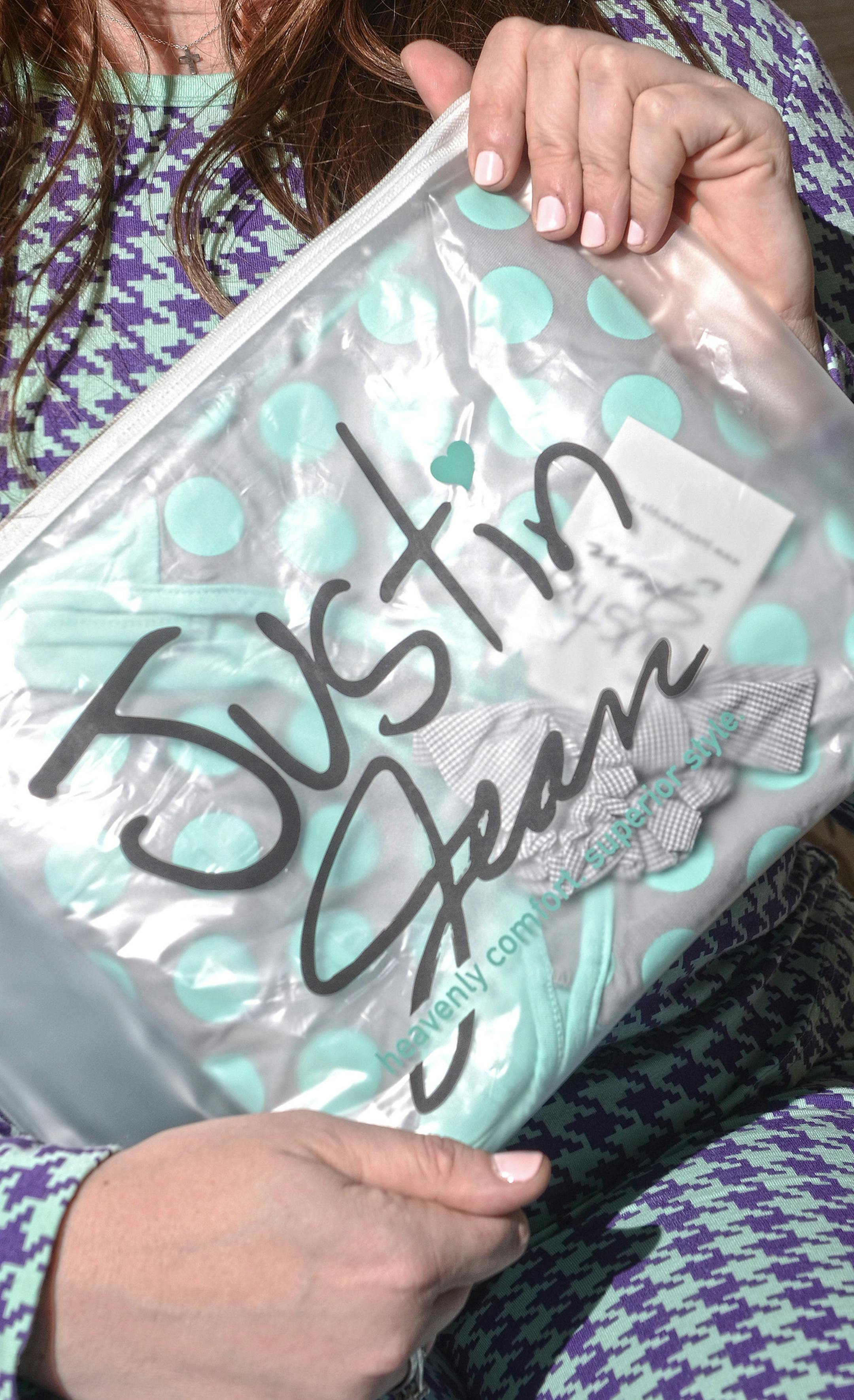 Lauren Raja, founder of Justin & Jean Pajamas, holds polka dot pajamas packaged in a travel bag. Raja is a New Hope-based PJ designer who created her own line of ruffled bottomed PJs, Justin & Jean, to help her cope with the loss of her husband. The PJs are the featured nightwear at the annual White Dog pajama brunch. (Jose F. Moreno/Philadelphia Inquirer/TNS) ORG XMIT: 1219181