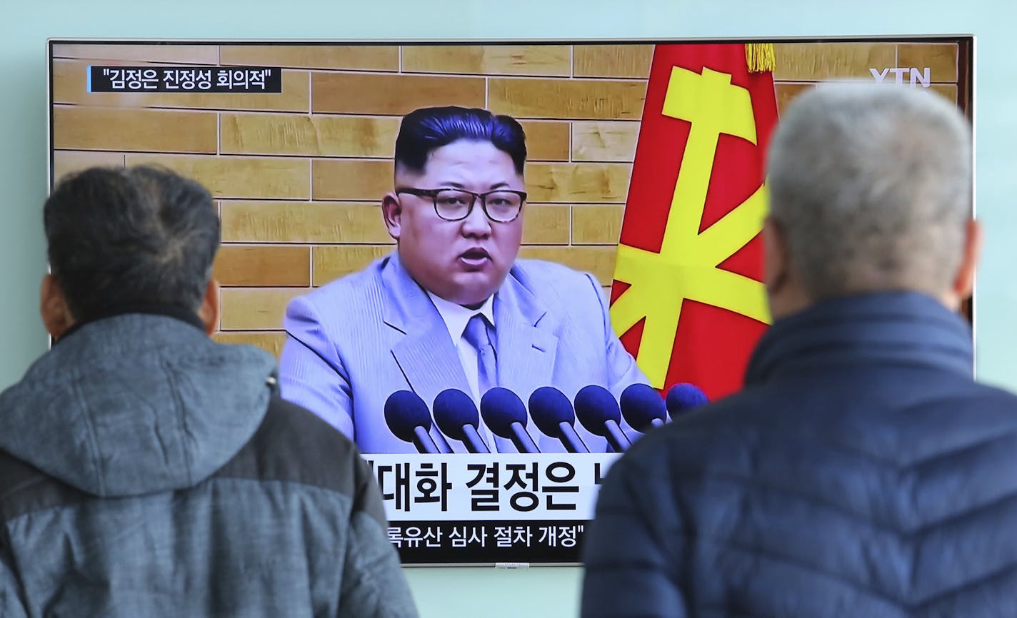 People watch a TV screen showing North Korean leader Kim Jong Un's New Year's speech, at Seoul Railway Station in Seoul, South Korea, Wednesday, Jan. 3, 2018. North Korea announced Wednesday that it will reopen a cross-border communication channel with South Korea, officials in Seoul said, another sign of easing animosity between the rivals after a year that saw the North conduct nuclear bomb and missile tests and both the Koreas and Washington issue threats of war. (AP Photo/Ahn Young-joon)