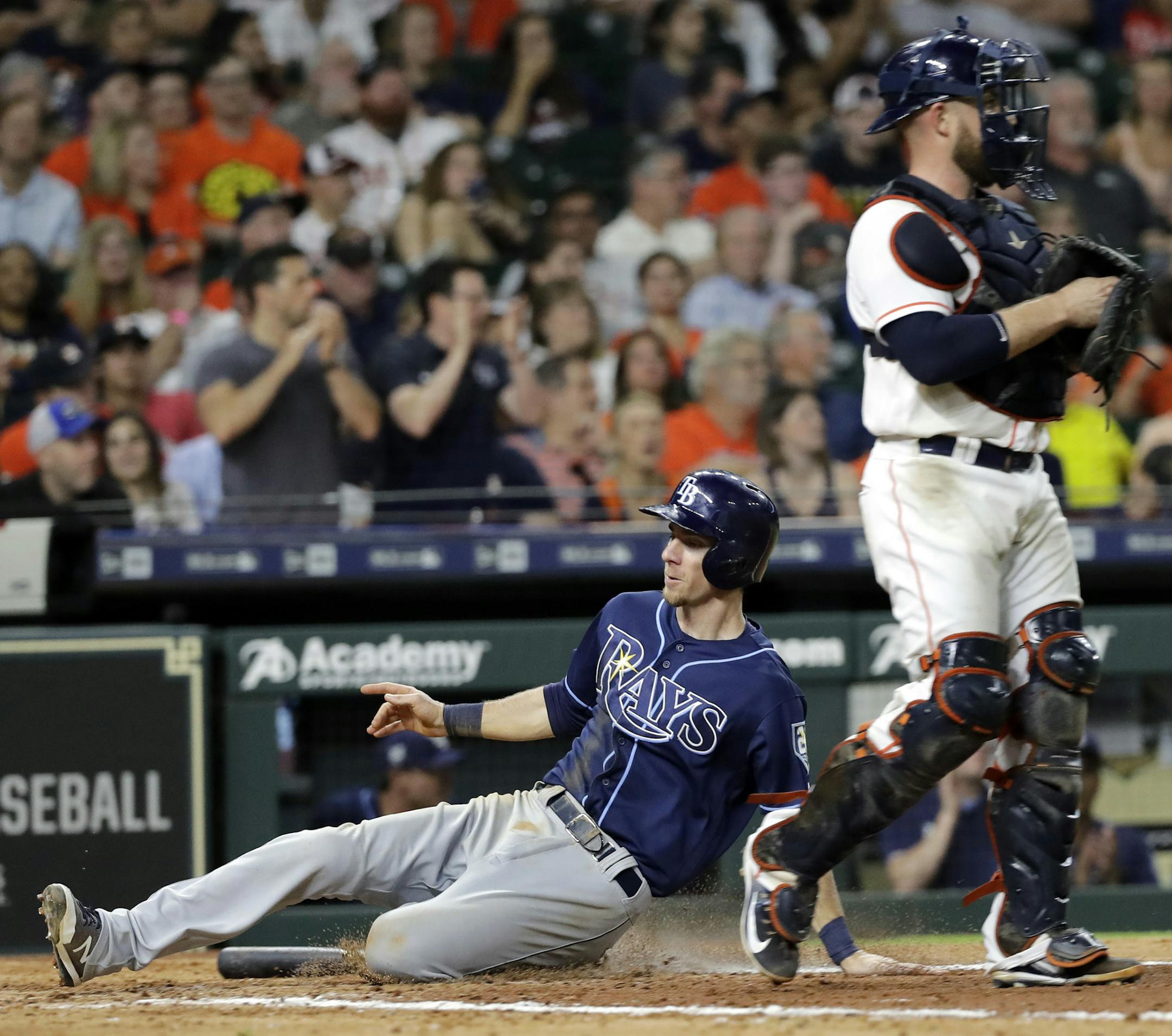 Tampa Bay Rays' Matt Duffy, left, scores as Houston Astros catcher Max Stassi looks to the outfield during the eighth inning of a baseball game Tuesday, June 19, 2018, in Houston. (AP Photo/David J. Phillip)
