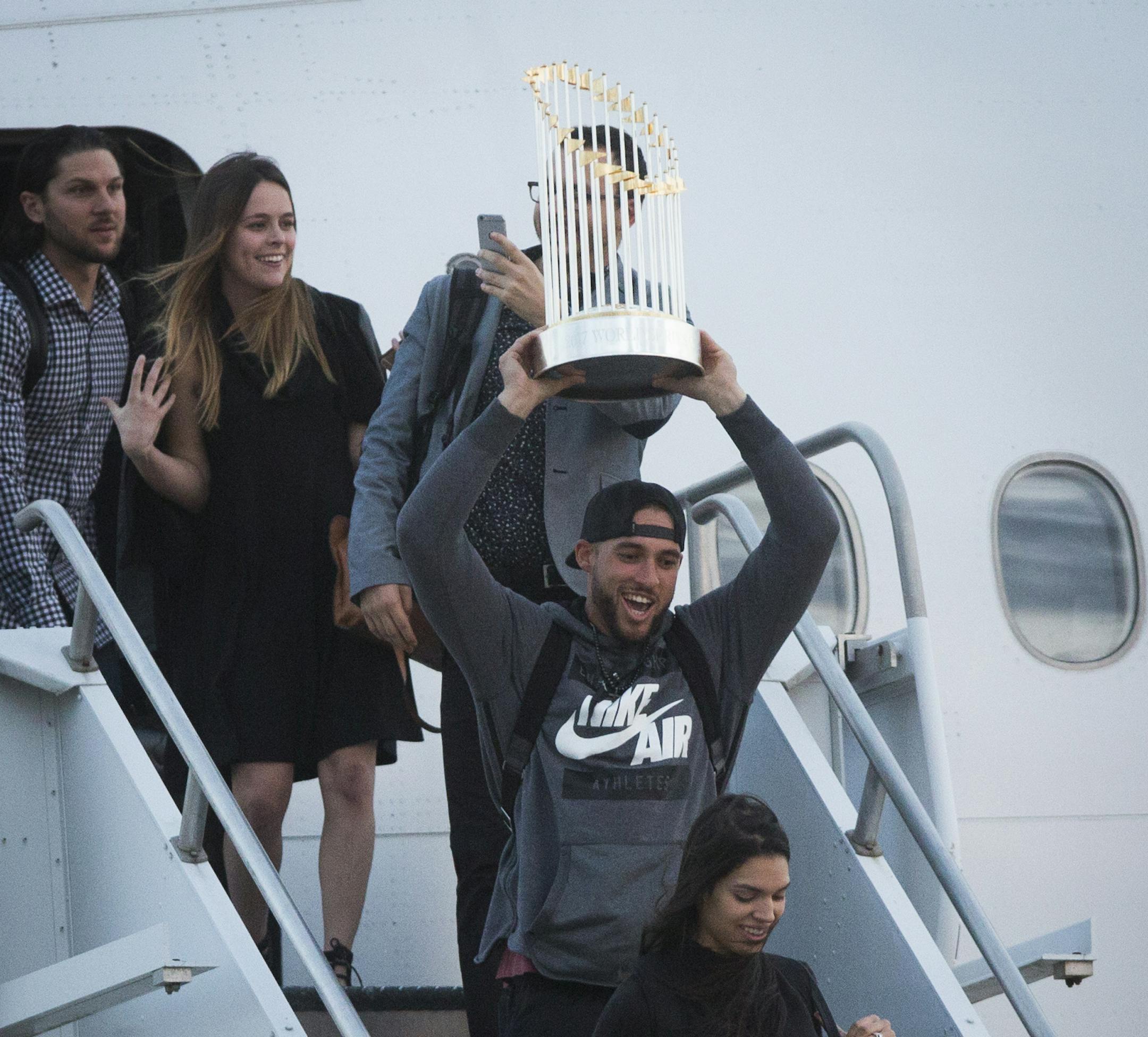 Houston Astros player George Springer arrives to Houston holding the Commissioner's Trophy, Thursday, Nov. 2, 2017, after winning the World Series against the Dodgers. ( Marie D. De Jesus / Houston Chronicle ) ORG XMIT: MER2017110220020591