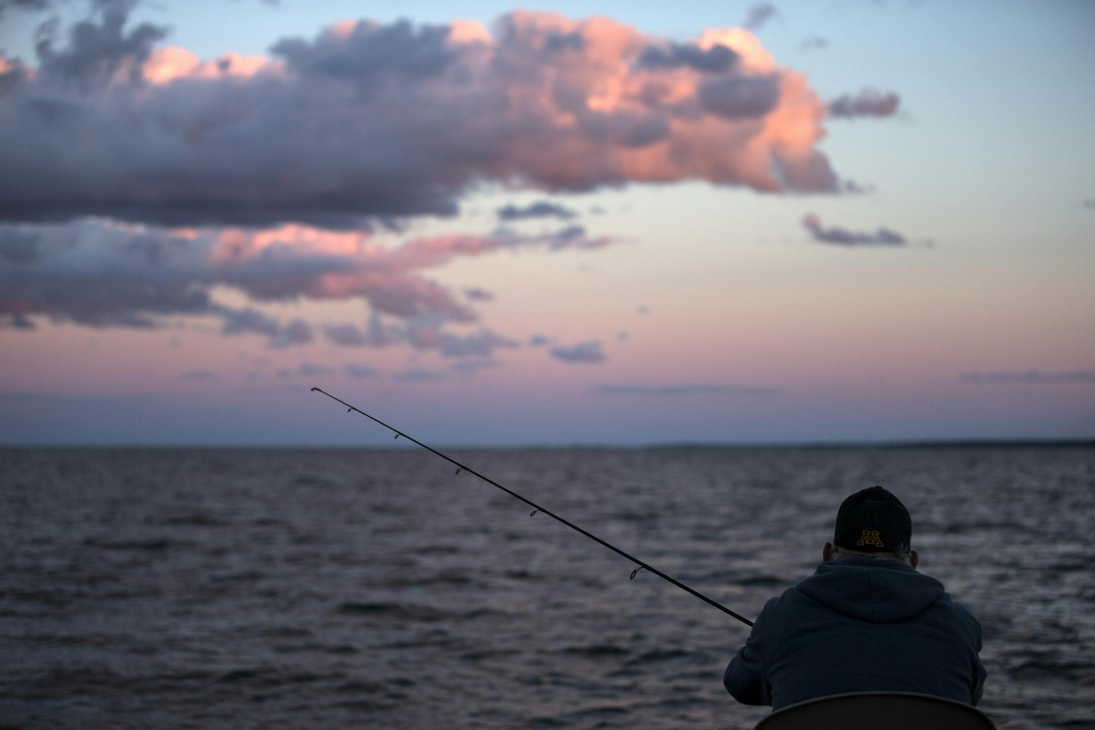 A fisherman looks for a catch during a fishing expedition with Twin Pines Resort on Mille Lacs Lake Monday, August 3, 2015.