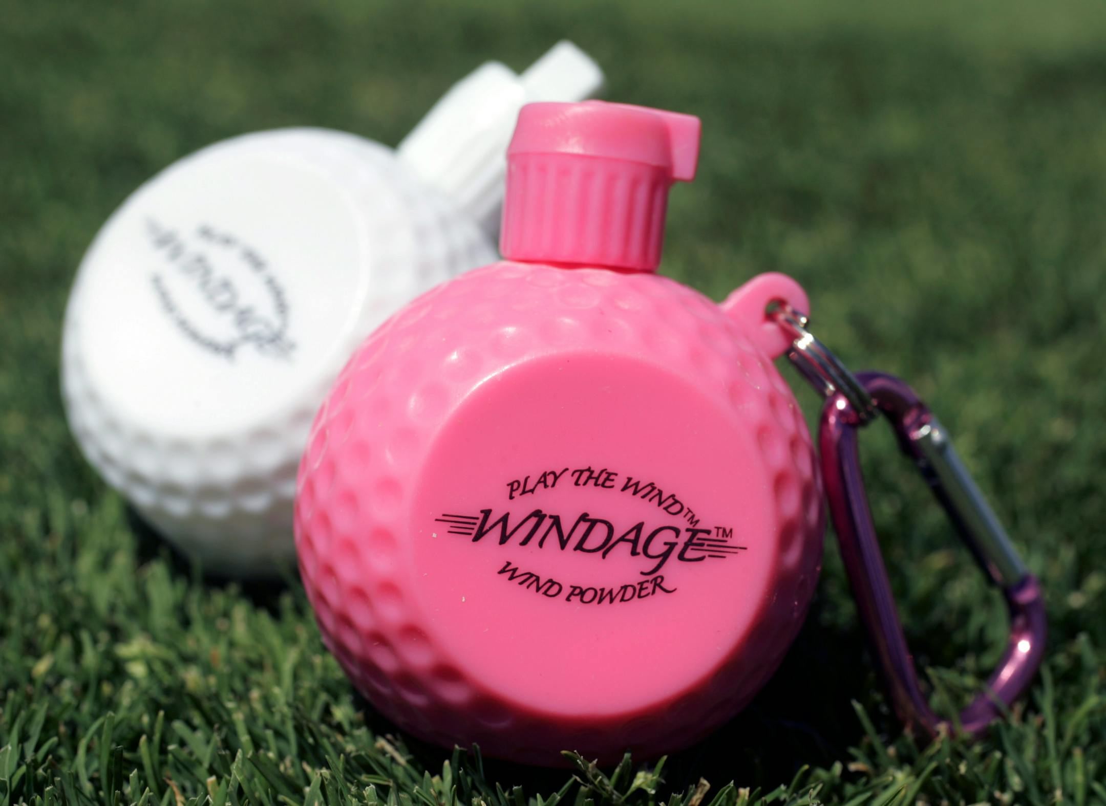 Windage replaces tossed-up blades of grass to help golfers determine the wind's direction. The product emits a puff of powder when squeezed.