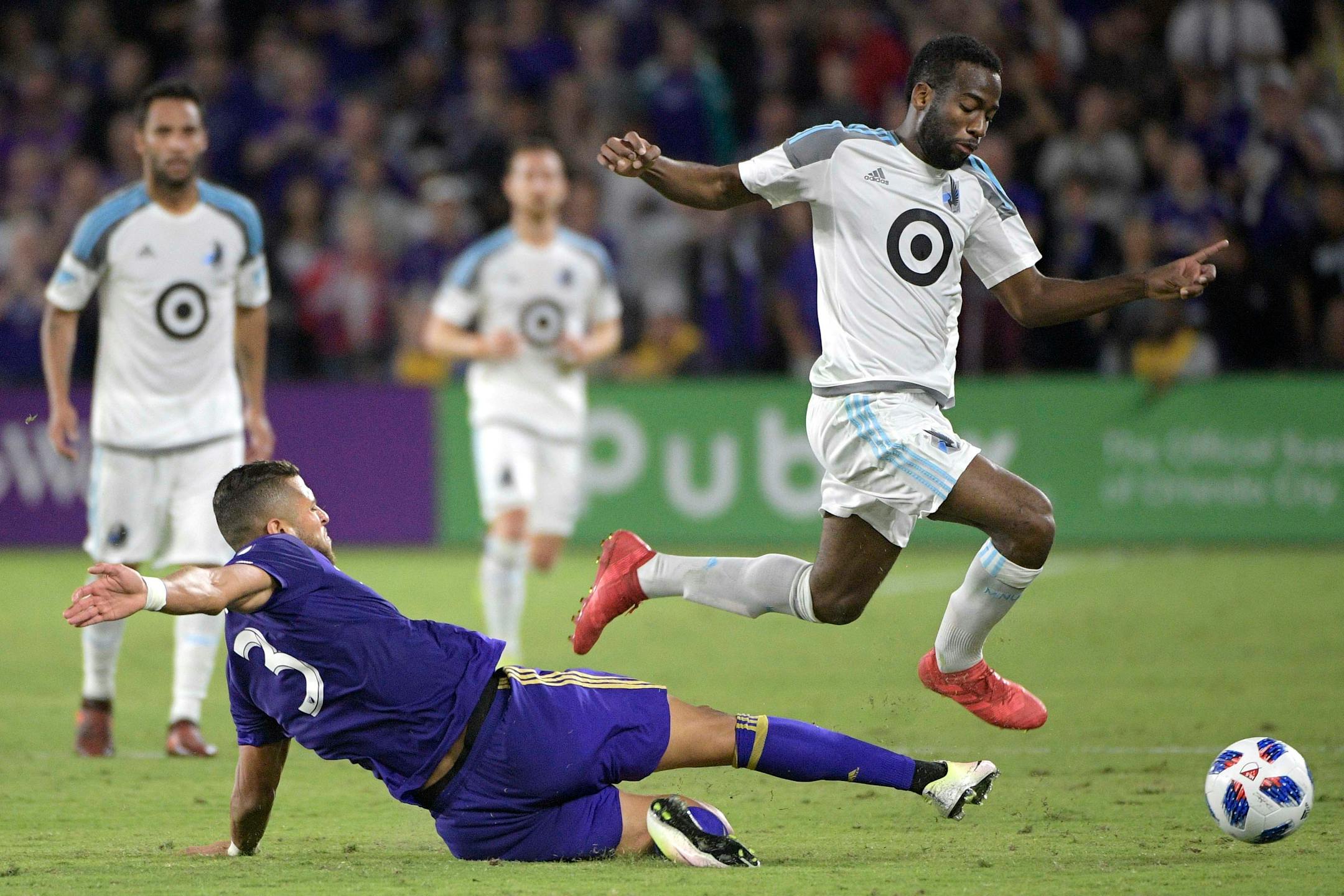 Orlando City defender Amro Tarek (3) kicks the ball out from under Minnesota United midfielder Kevin Molino (18) during the first half of an MLS soccer match Saturday, March 10, 2018, in Orlando, Fla. Minnesota won 2-1. (Phelan M. Ebenhack for the Star-Tribune) ORG XMIT: OTKMINN118