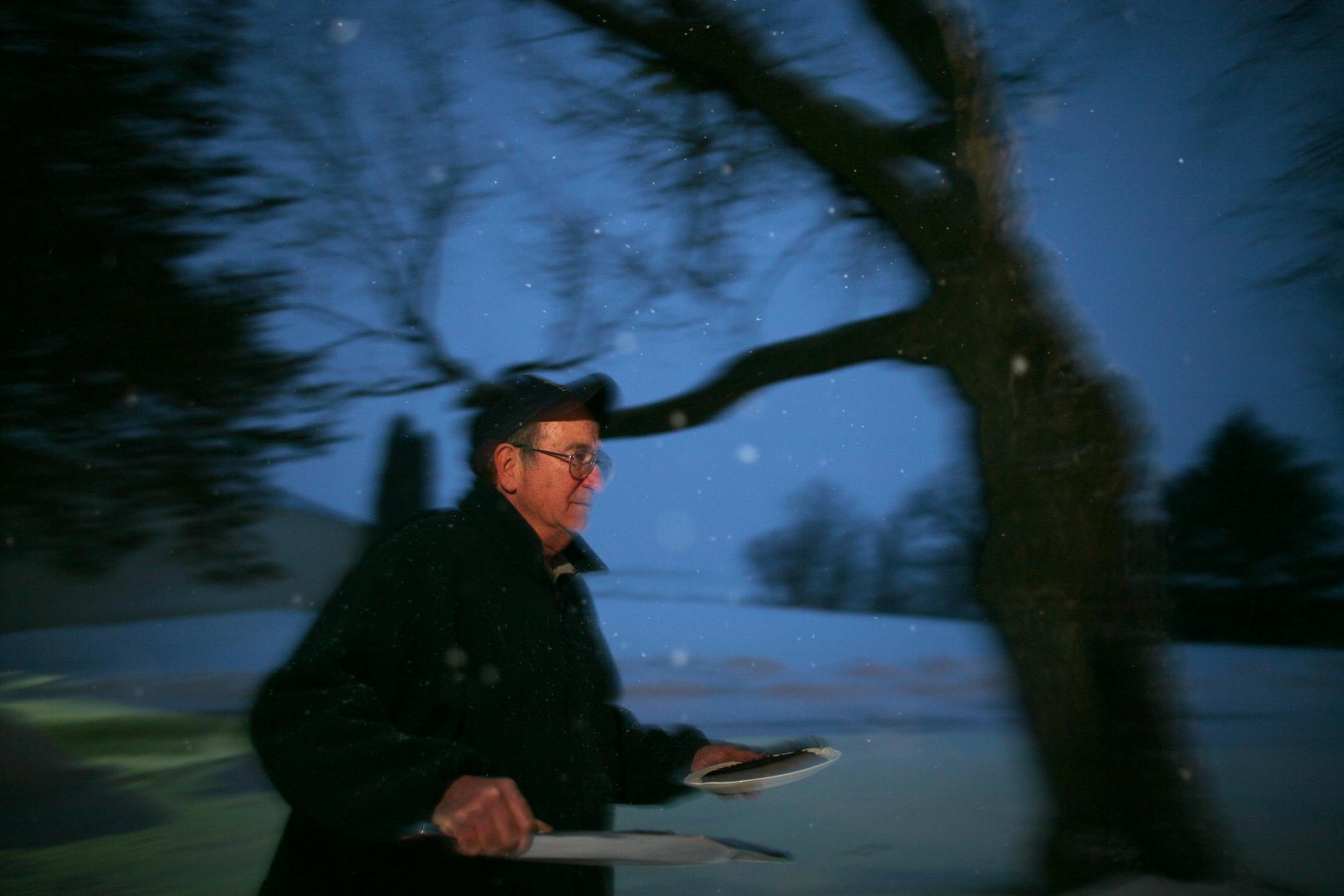 Bill Klein carried the apple wood smoked salmon from his barn to his house where his guests were waiting.