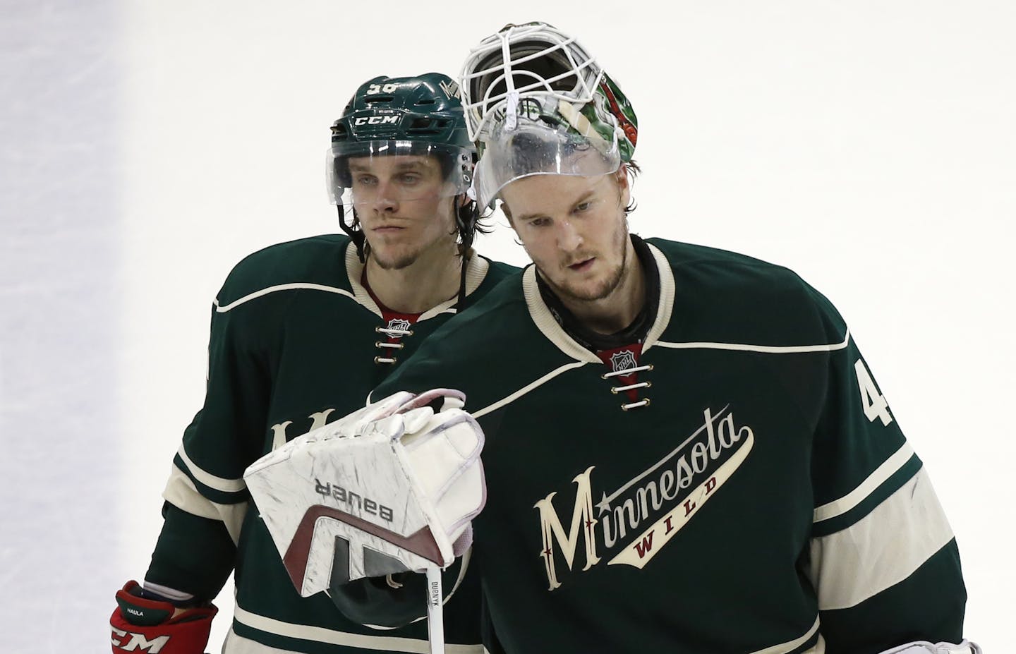 Minnesota Wild left wing Erik Haula (56) and goalie Devan Dubnyk (40) left the ice dejected after their 4-3 loss to Chicago Thursday night. ] CARLOS GONZALEZ cgonzalez@startribune.com, May 7, 2015, St. Paul, MN, Xcel Energy Center, NHL, Minnesota Wild vs. Chicago Blackhawks, Game 4, Stanley Cup Playoffs, Round 2