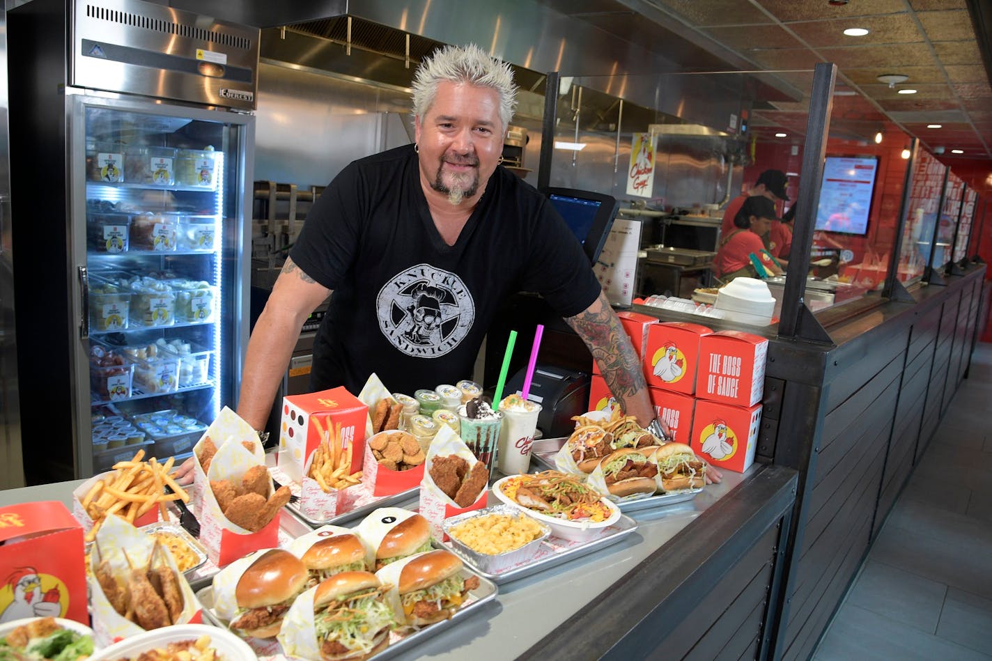 Lake Buena Vista, Fla. (August 30, 2018) - Chef Guy Fieri was at Chicken Guy! at Disney Springs today for a special ribbon-cutting ceremony. Hundreds of guests were lined up in anticipation of the ceremony and were rewarded for their enthusiasm with a tasty treat, as Fieri handed out samples of his chicken tenders and many of his 22 signature sauces to the hungry crowd. Thursday, Aug. 30, 2018, in Lake Buena Vista, Fla. (Phelan M. Ebenhack)