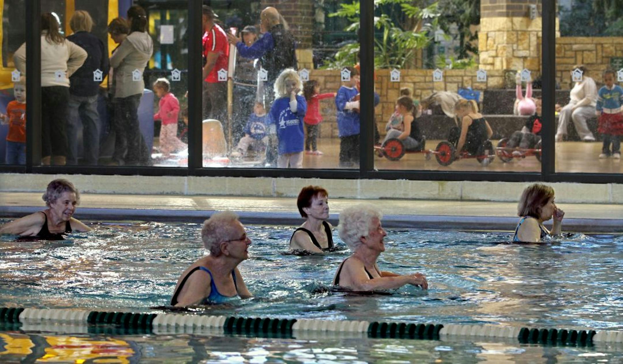 Seniors took part in the morning stretching and toning class at the Edinborough Park pool, as children and parents played in the play area next to the pool on 2/9/12. Seniors who live near Edinborough Park in Edina are pelting the City Council with letters protesting the possible elimination of the park's lap pool. Last month, a consultant suggested the city close the pool to update the facility. That's hasn't gone over well with seniors who live in the Edinborough condo building or in nearby ap
