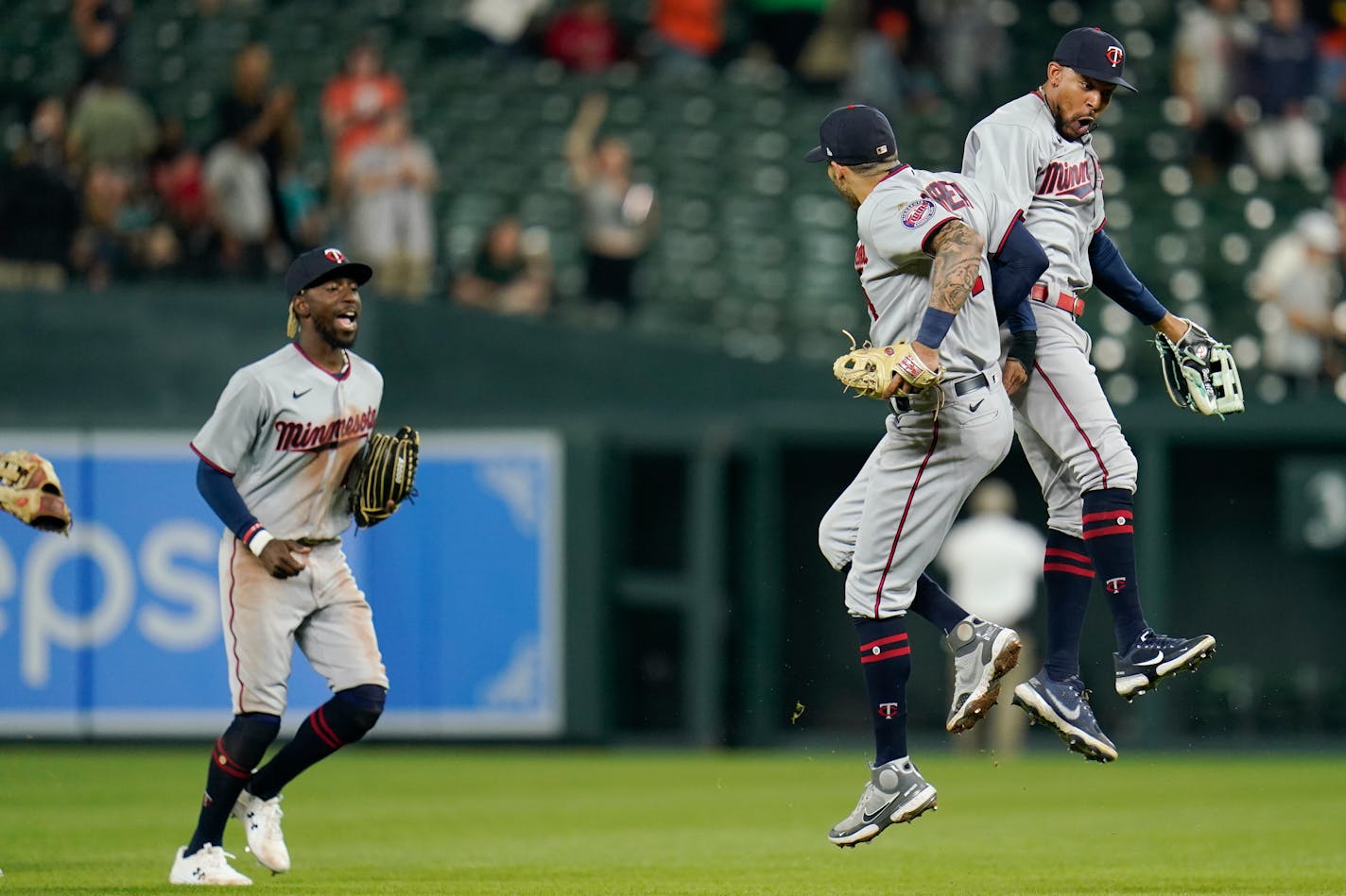 Minnesota Twins left fielder Nick Gordon, left, shortstop Carlos Correa, center, and center fielder Byron Buxton react after a baseball game against the Baltimore Orioles, Monday, May 2, 2022, in Baltimore. The Twins won 2-1. (AP Photo/Julio Cortez)