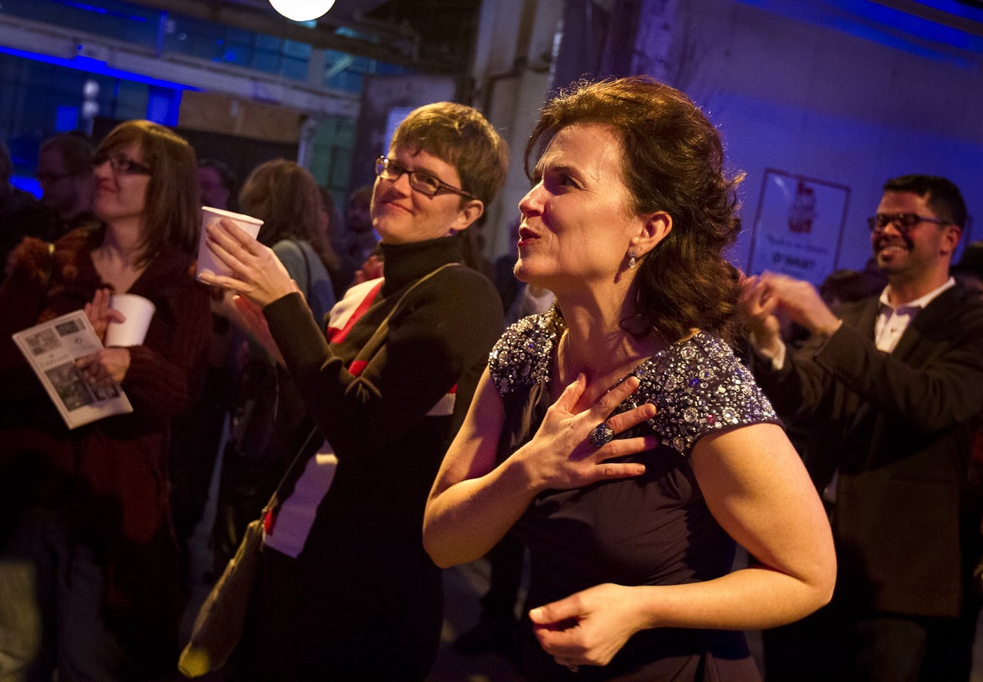 Minneapolis Mayor Betsy Hodges responds to a song by the Minneapolis Gay Men's Chorus during her inauguration party at the historic Thorp Building in Northeast Minneapolis, Saturday, January 11, 2014. [ BEN BREWER • Special to the Star Tribune _ Assignment # 118454 DATE 1/11/14 SLUG: FACE011414 EXTRA INFORMATION: Conclusion of "One Minneapolis" promotion over the past ten days with a focus on the arts and entertainment scene in the city.