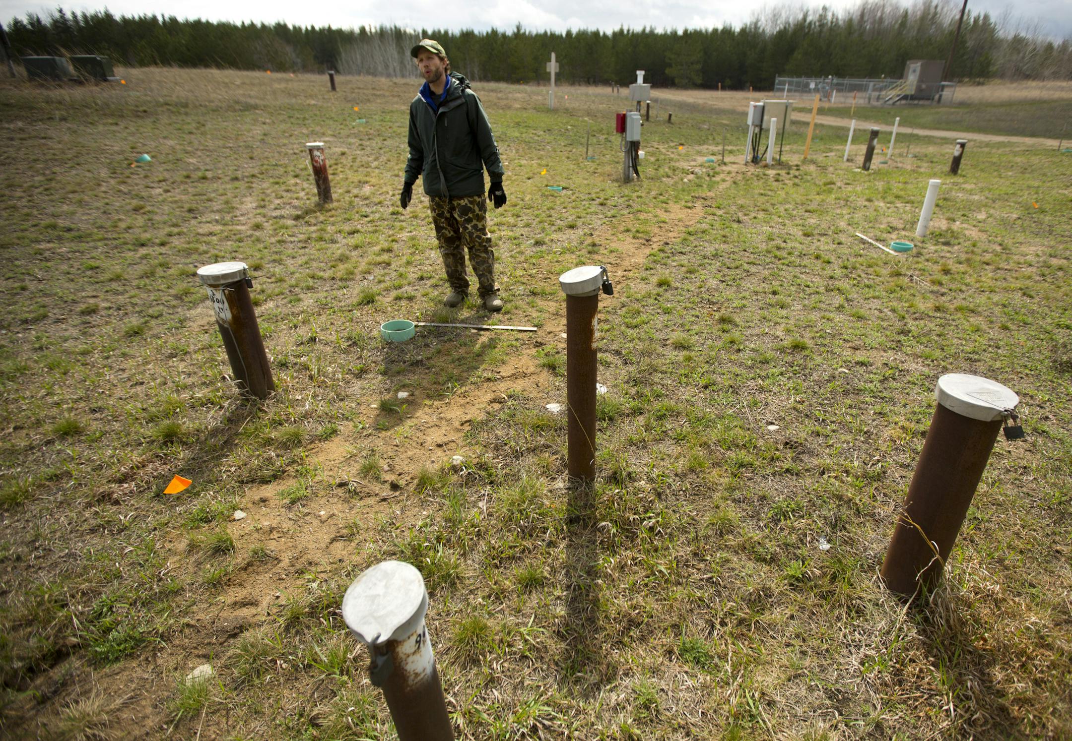 At the site of 1979 crude oil pipeline rupture near Bemidji, Minn., scientists have dotted the landscape with bore holes to study of the lingering underground pollution. Here, US Geological Survey hydrologist Jared Trost stands among the many bore holes used by scientists to study the movement and breakdown of crude oil that flowed through soil to the water table. ] BRIAN PETERSON ‚Ä¢ brian.peterson@startribune.com Solway, MN 5/12/2014