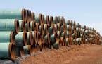 FILE - In this Feb. 1, 2012 file photo, miles of pipe for the stalled Canada-to-Texas Keystone XL pipeline are stacked in a field near Ripley, Okla. A